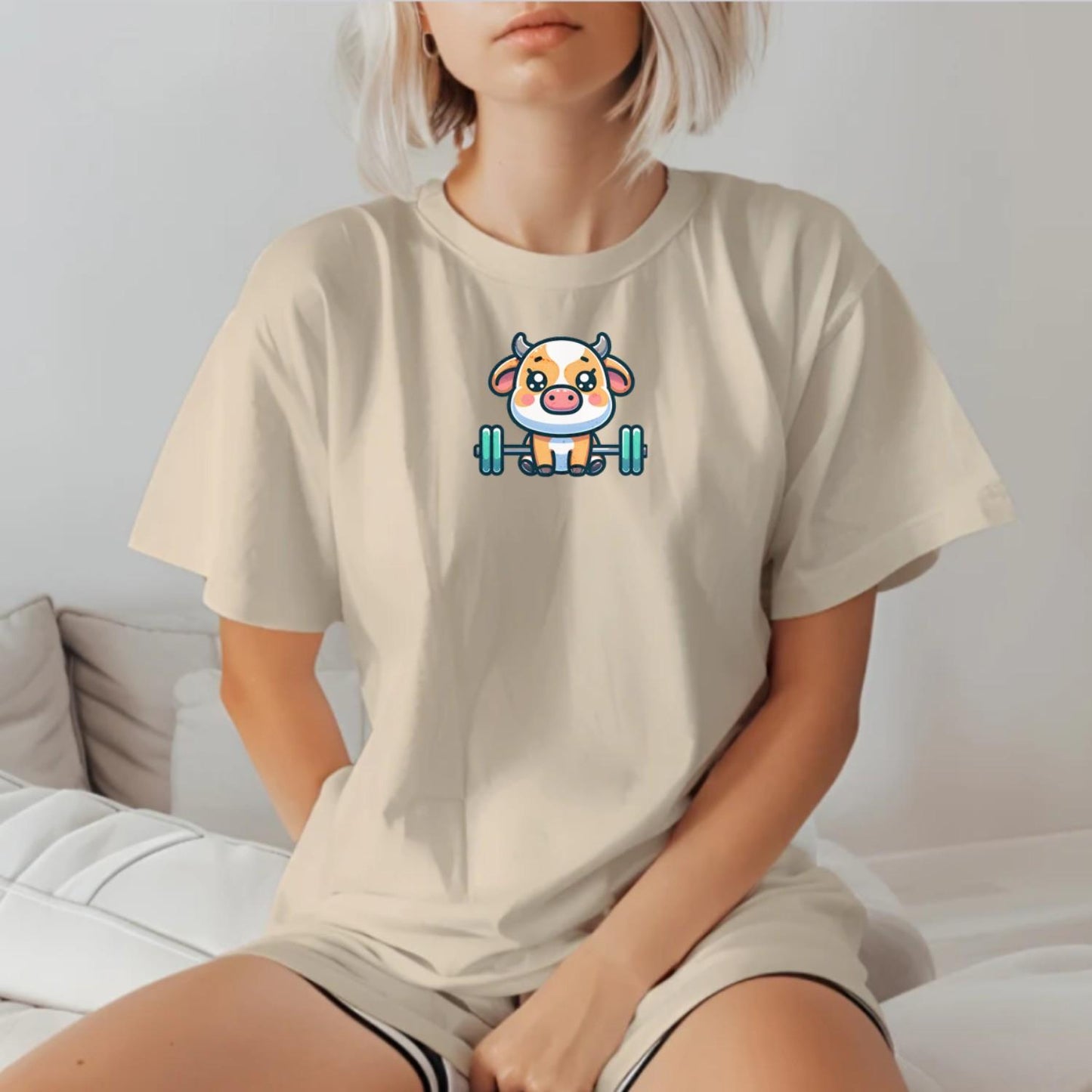"Adorable Cow Gym T-Shirt featuring a cute cow lifting weights, perfect for fitness enthusiasts who enjoy humor and unique style."