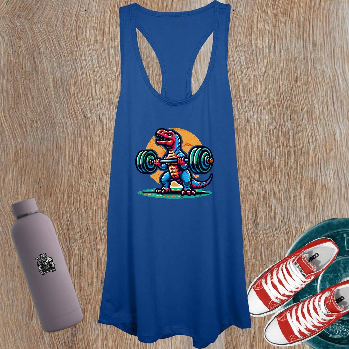 "Vibrant women's tank top featuring a playful dinosaur lifting weights, perfect for gym sessions and casual outings, promoting strength."