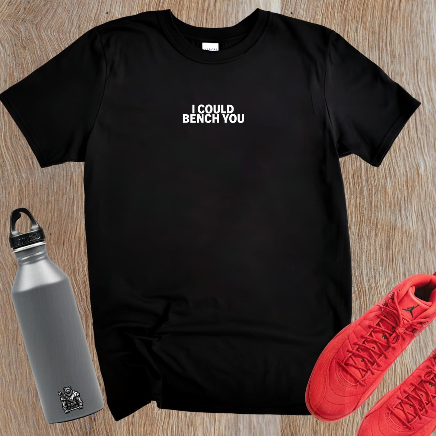 Alt text: "Bold fitness T-shirt featuring 'I Could Bench You' slogan, ideal for gym enthusiasts who lift with confidence and style."