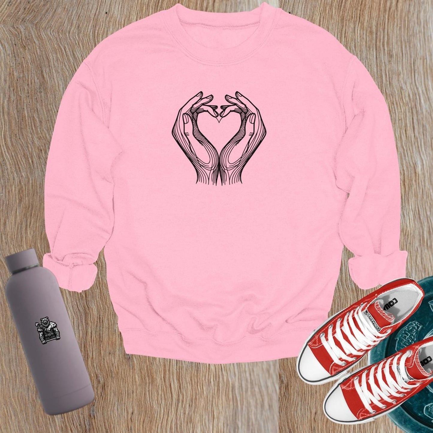 "Stylish gym sweatshirt featuring a heart formed by hands, perfect for fitness lovers. Comfortable, trendy activewear for workouts."