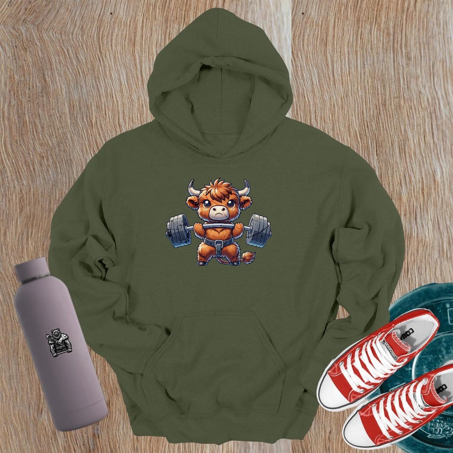 "Cartoon bull lifting weights on a stylish gym hoodie, embodying strength and motivation for gym enthusiasts and fitness lovers."