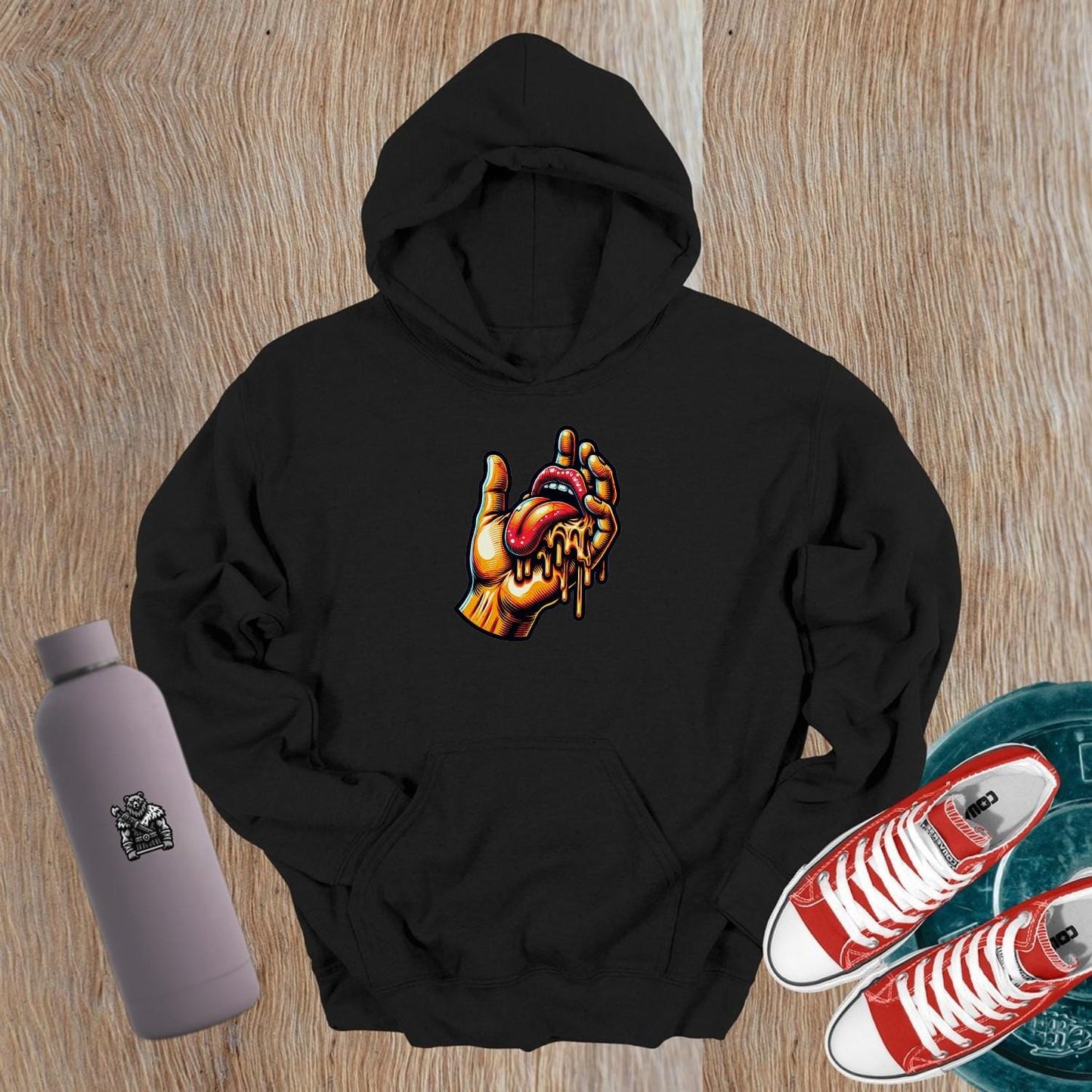 "Bold gym hoodie featuring vibrant graphic of a hand and dripping tongue, perfect for workouts and casual outings, embodying fierce style."