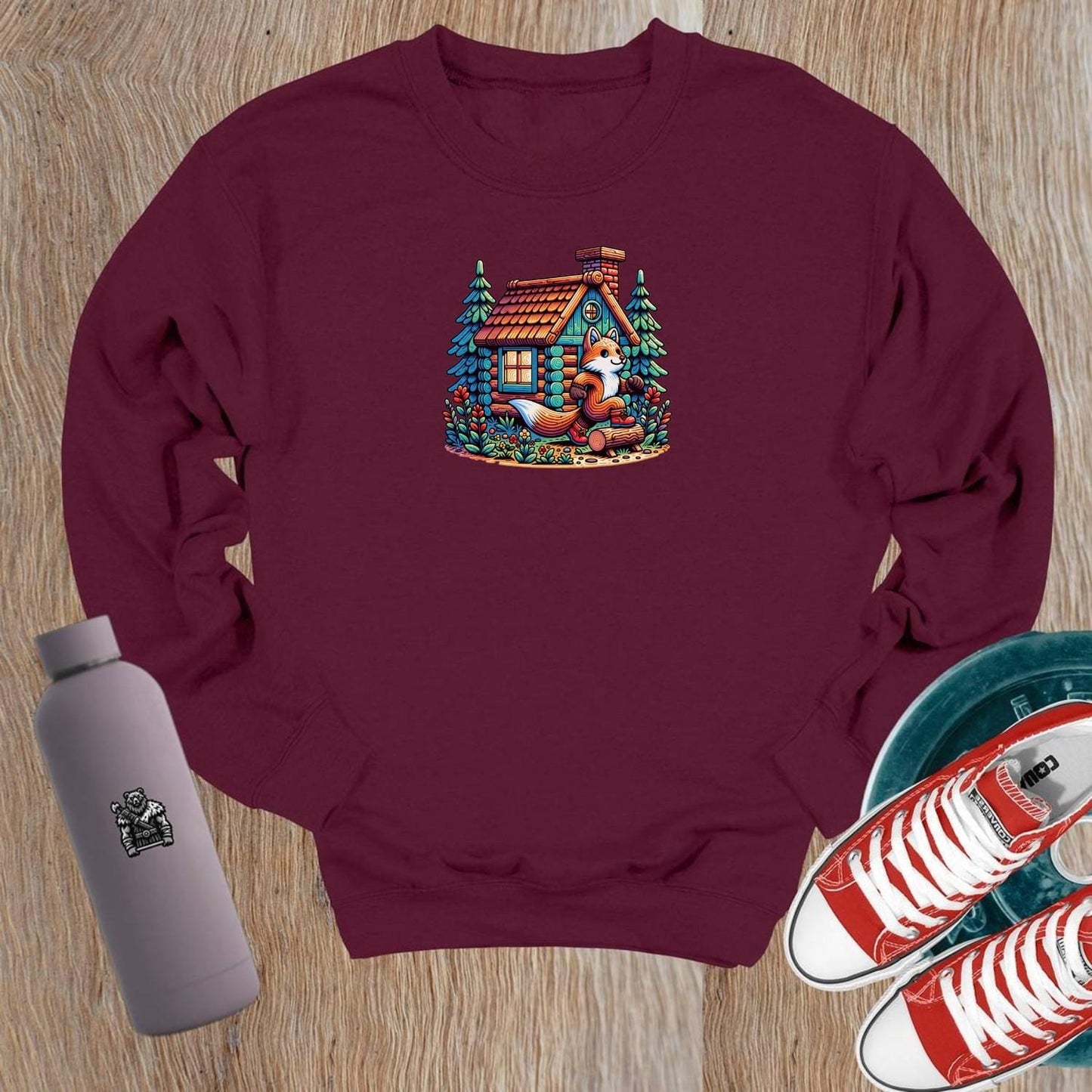 "Cozy crewneck sweatshirt featuring a playful fox beside a charming log cabin, perfect for gym workouts or casual lounging."