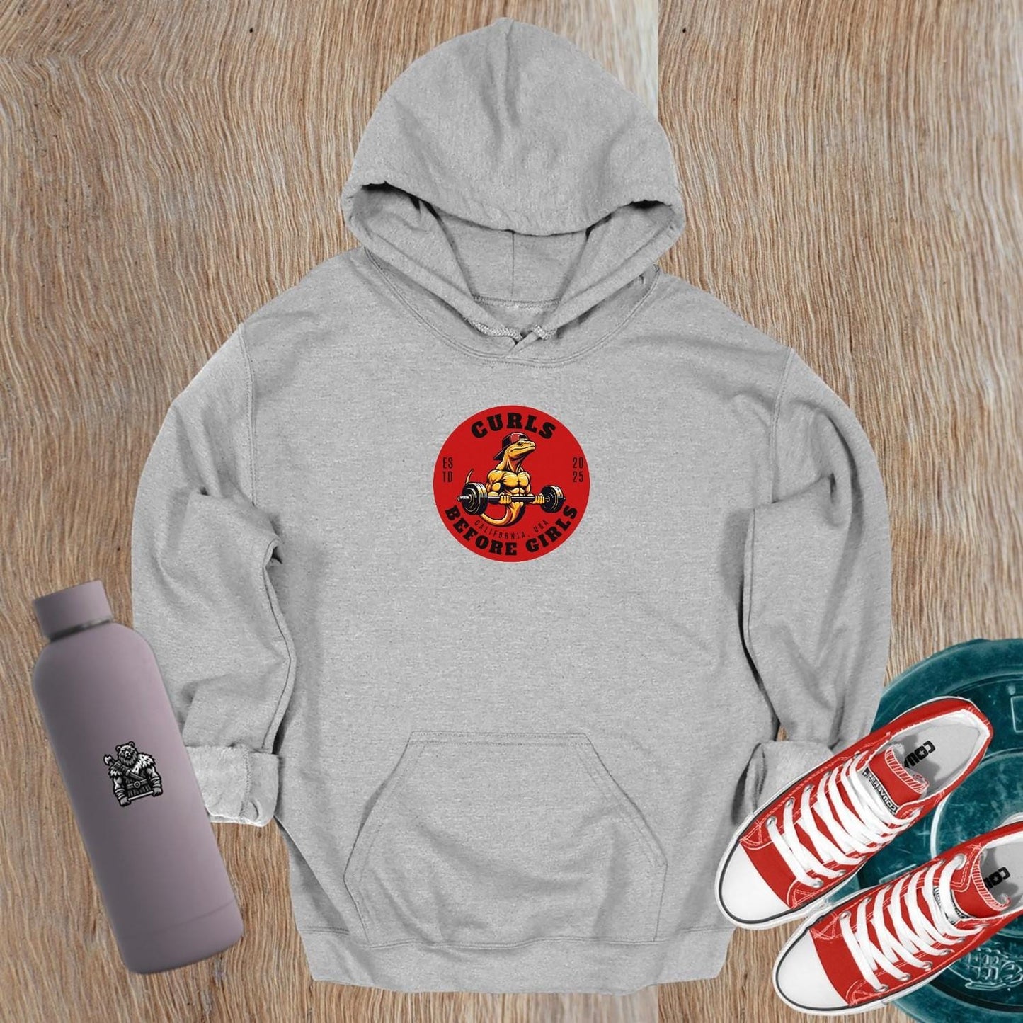 "Graphic hoodie featuring 'Curls Before Girls' slogan, vibrant design for fitness enthusiasts, perfect for gym and casual wear."