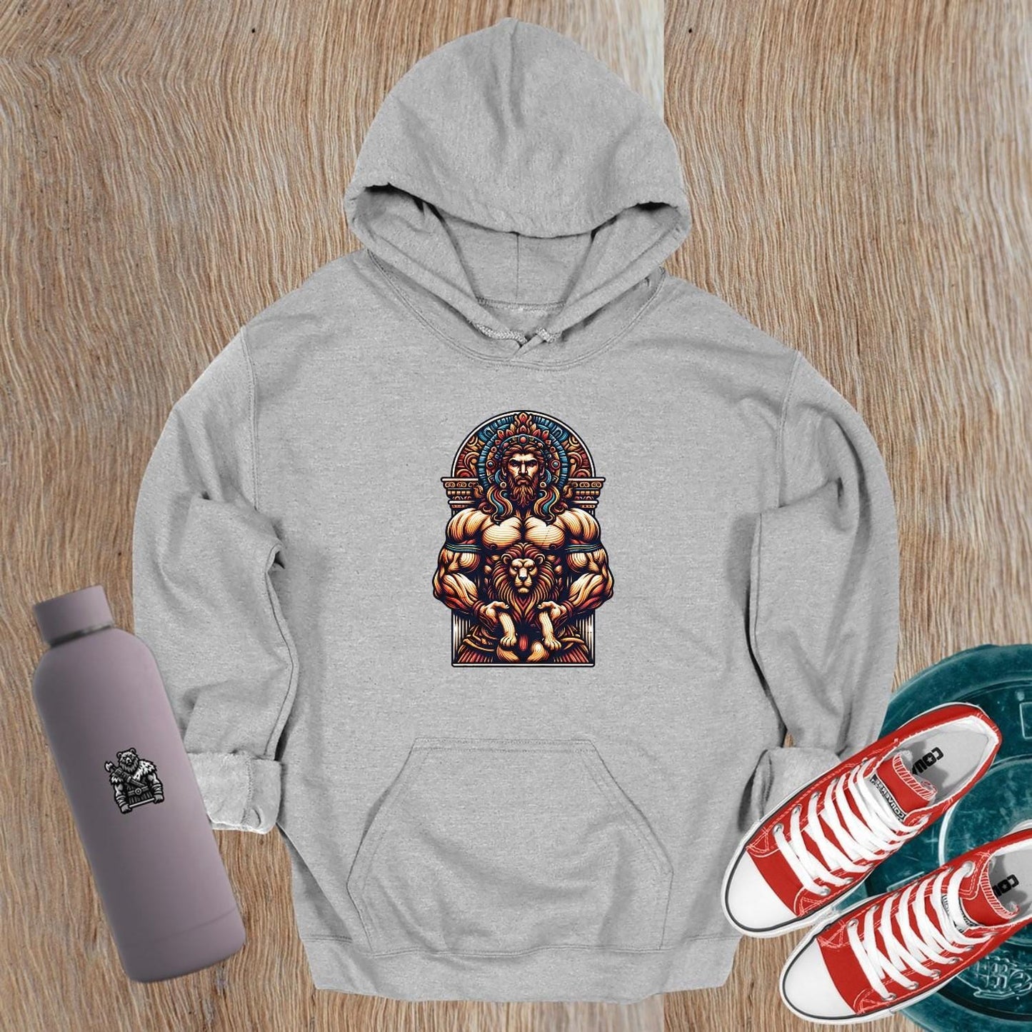 "Graphic gym hoodie featuring a muscular figure and fierce lion design, symbolizing strength, courage, and resilience for workout wear."