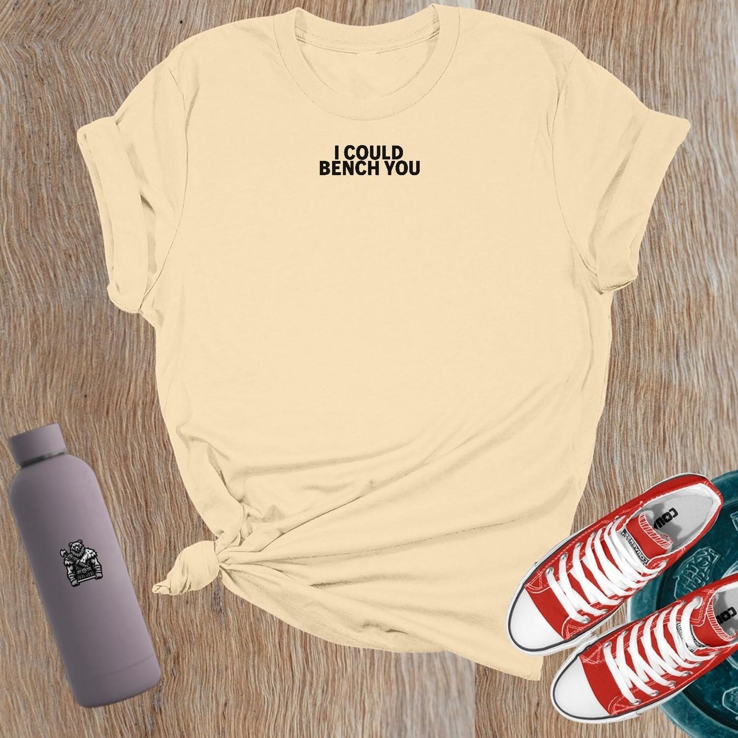 "Bold 'I Could Bench You' graphic on a flattering women's gym T-shirt, perfect for female lifters and fitness enthusiasts."