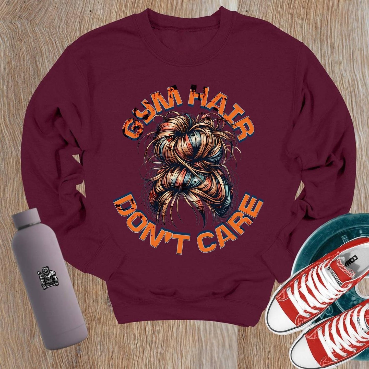 Alt text: "Vibrant crewneck sweatshirt featuring bold 'Gym Hair Don't Care' graphic, ideal for workouts or lounging, showcasing fitness flair."