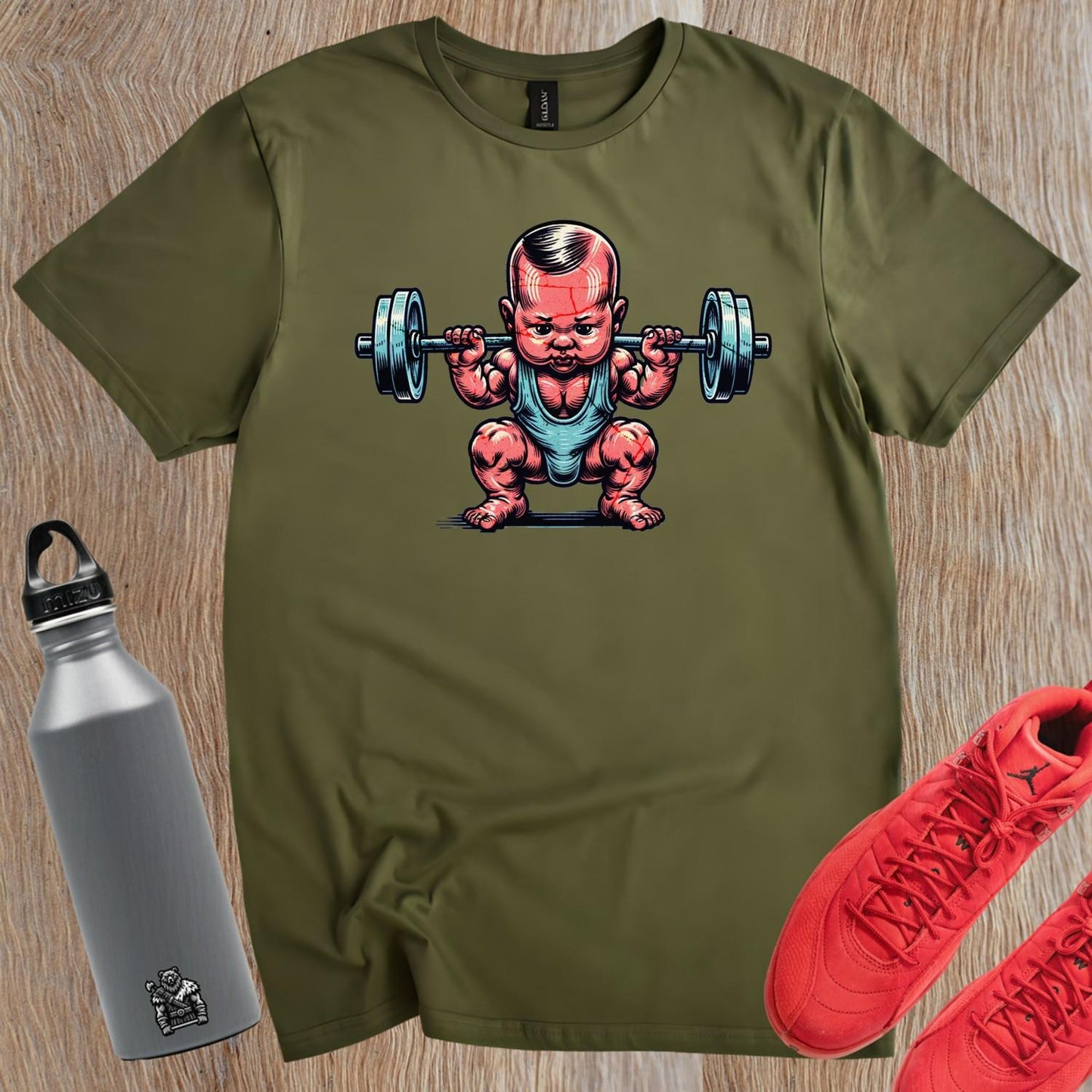 "Fun gym T-shirt featuring a charming baby lifting weights, combining humor and strength for fitness enthusiasts. Perfect for workouts!"