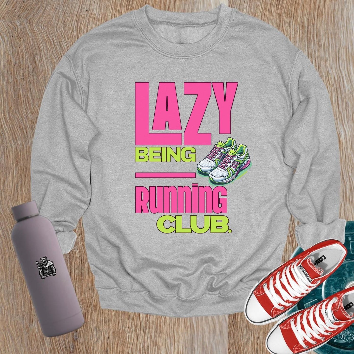 "Vibrant 'Lazy Being Running Club' sweatshirt featuring playful graphics, perfect for fitness enthusiasts and casual wearers at the gym."