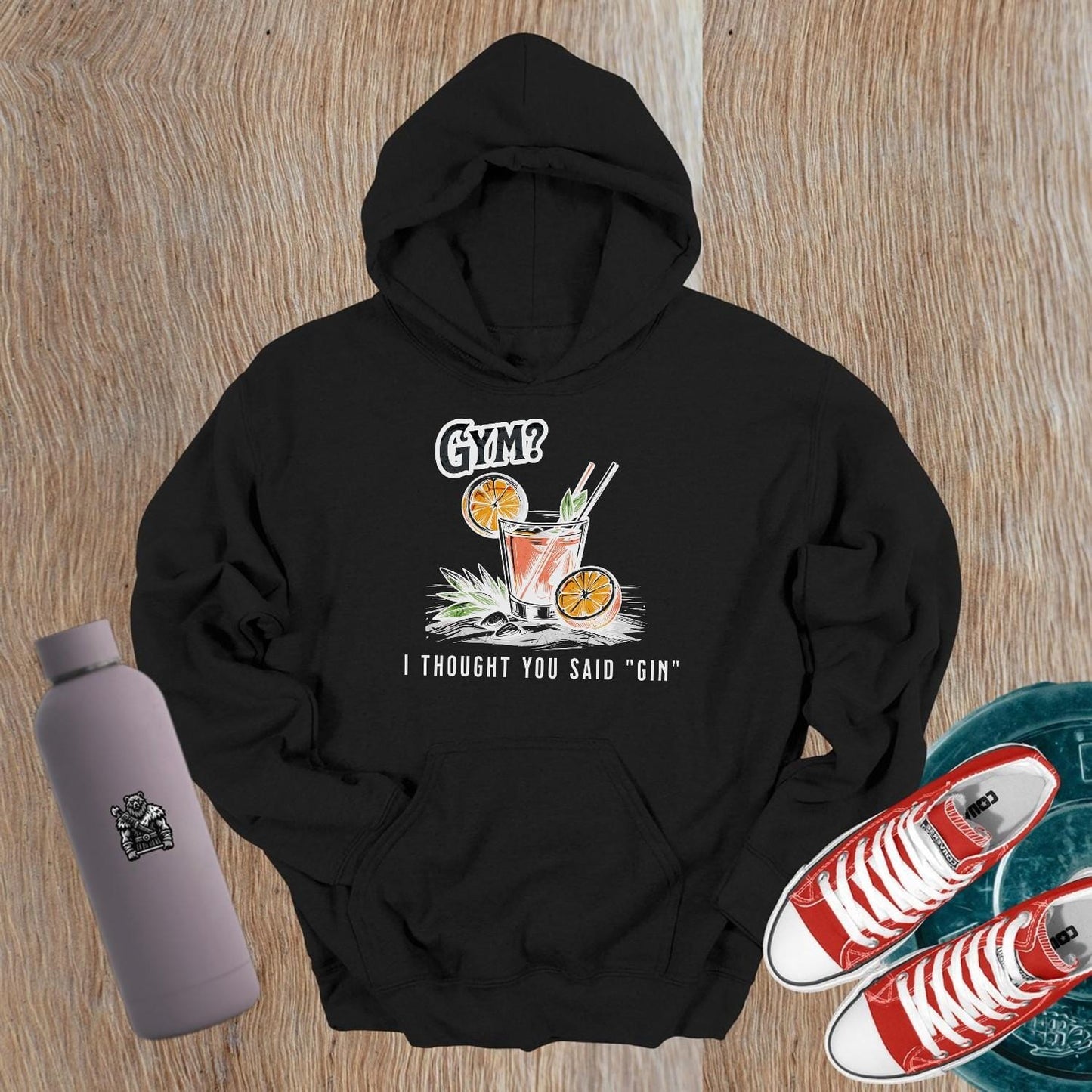 Graphic gym hoodie featuring the slogan "Gym? I thought you said 'gin.'" in playful font, perfect for fitness lovers and casual wear.