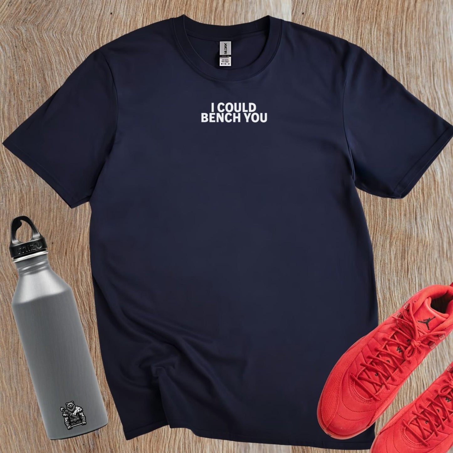 Alt text: "Bold fitness T-shirt featuring 'I Could Bench You' slogan, ideal for gym enthusiasts who lift with confidence and style."