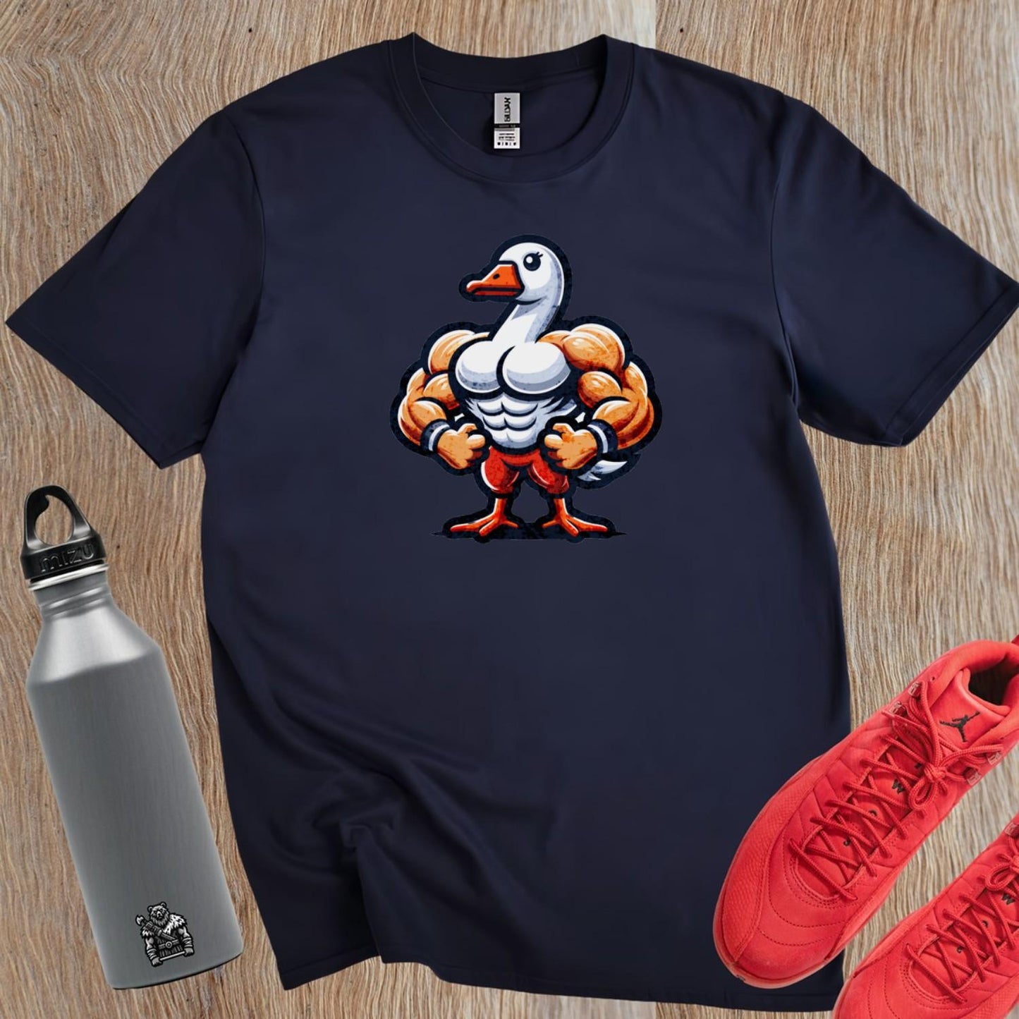 "Bold gym T-shirt featuring a muscle-bound goose design, perfect for workouts, fitness enthusiasts, and making a fun statement."