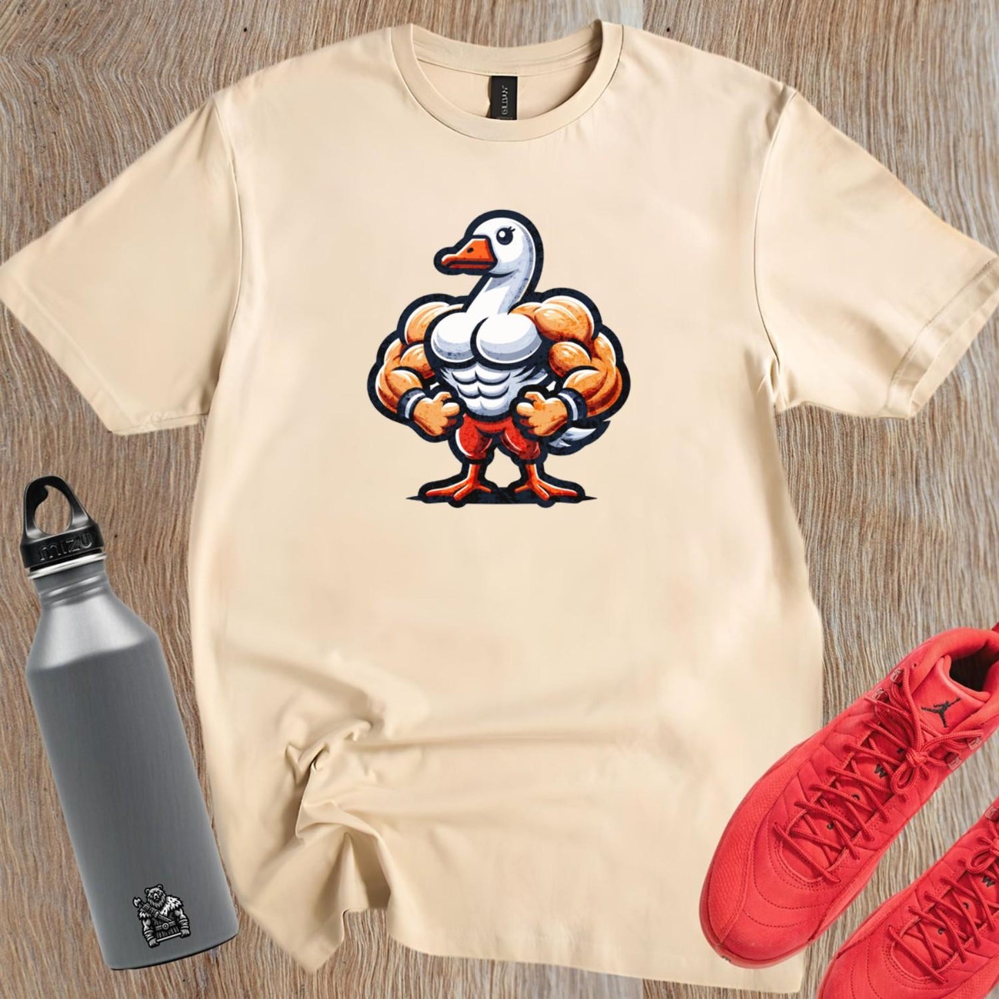 Alt text: "Muscular duck graphic T-shirt for gym enthusiasts, featuring a bold design that combines fun and fitness in a relaxed fit."