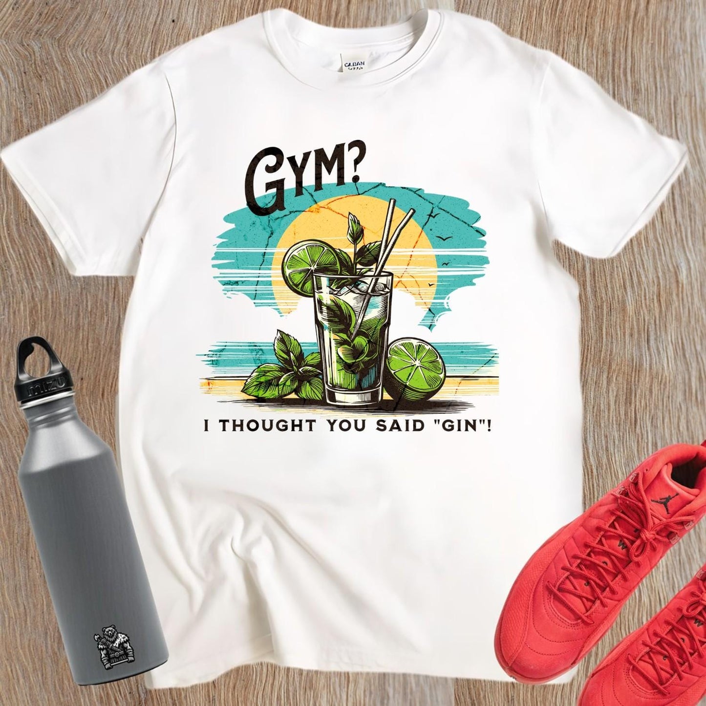 Alt text: "Fun graphic T-shirt featuring the humorous phrase 'GYM? I Thought You Said 'GIN'!' Perfect for fitness lovers and gym enthusiasts."