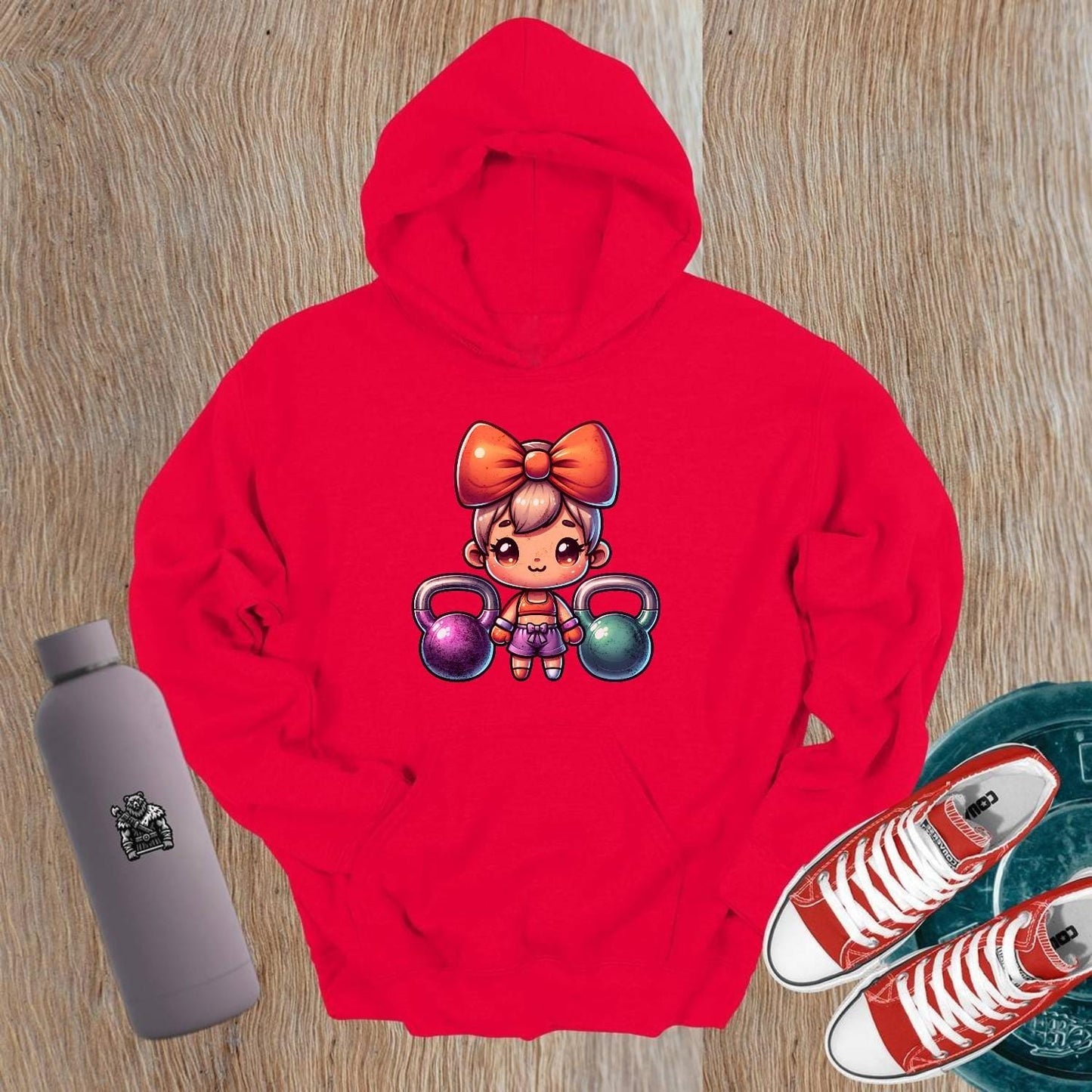 "Vibrant gym hoodie featuring a playful character lifting kettlebells, perfect blend of style and function for workouts and casual wear."