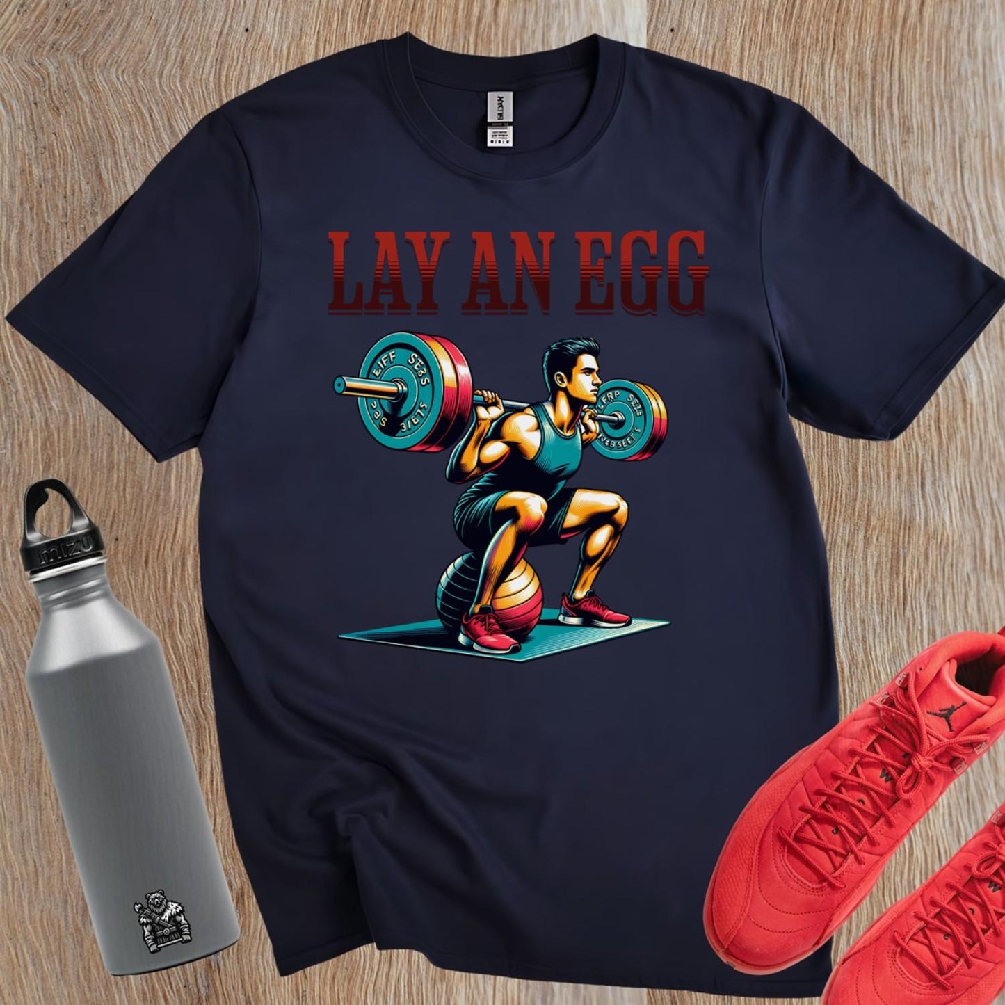 "Graphic gym T-shirt featuring 'Lay An Egg' design, showcasing humor in fitness. Ideal for workouts, casual outings, and style."