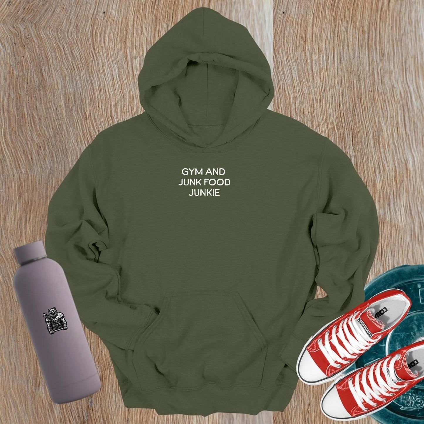"Stylish 'Gym and Junk Food Junkie' hoodie featuring bold text, perfect for fitness lovers balancing workouts and indulgent treats."