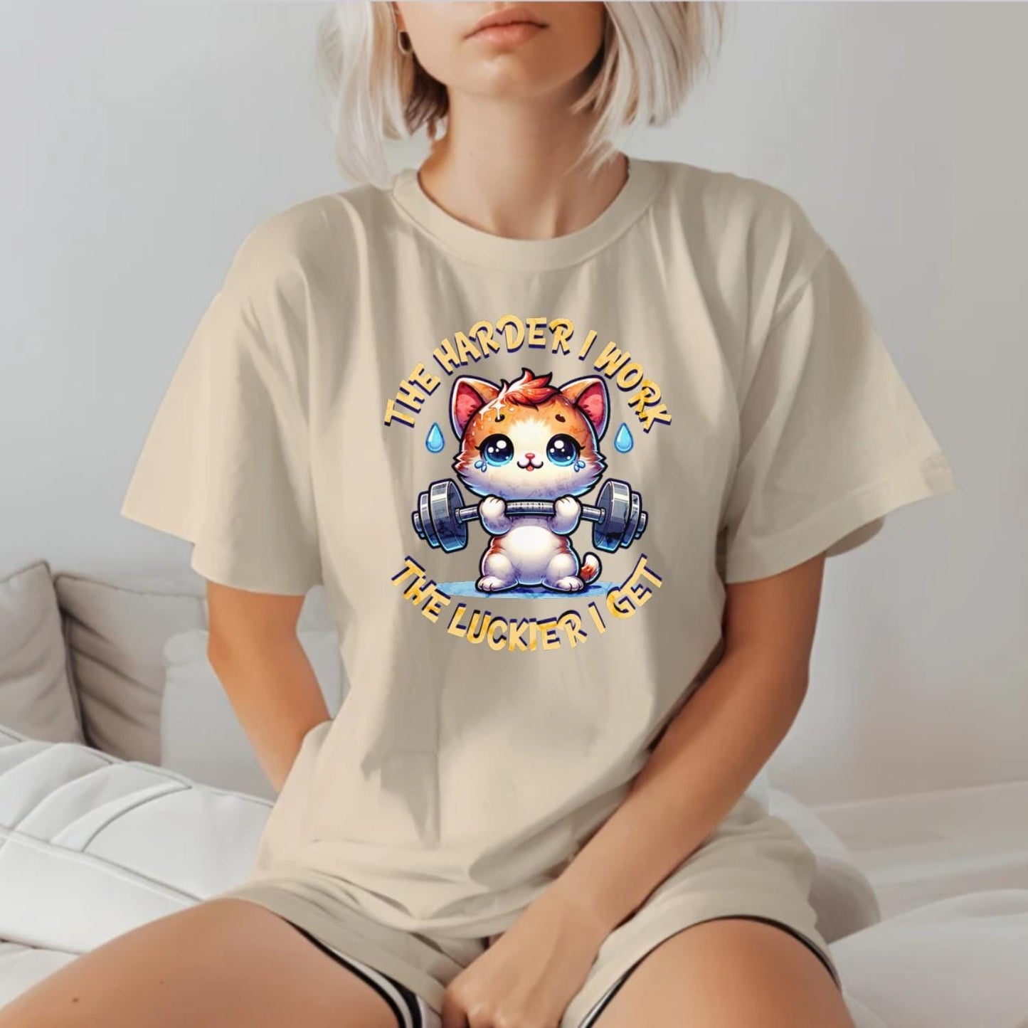 "Vibrant gym T-shirt featuring a determined kitty lifting weights, inspiring fitness enthusiasts with playful motivation for workouts."