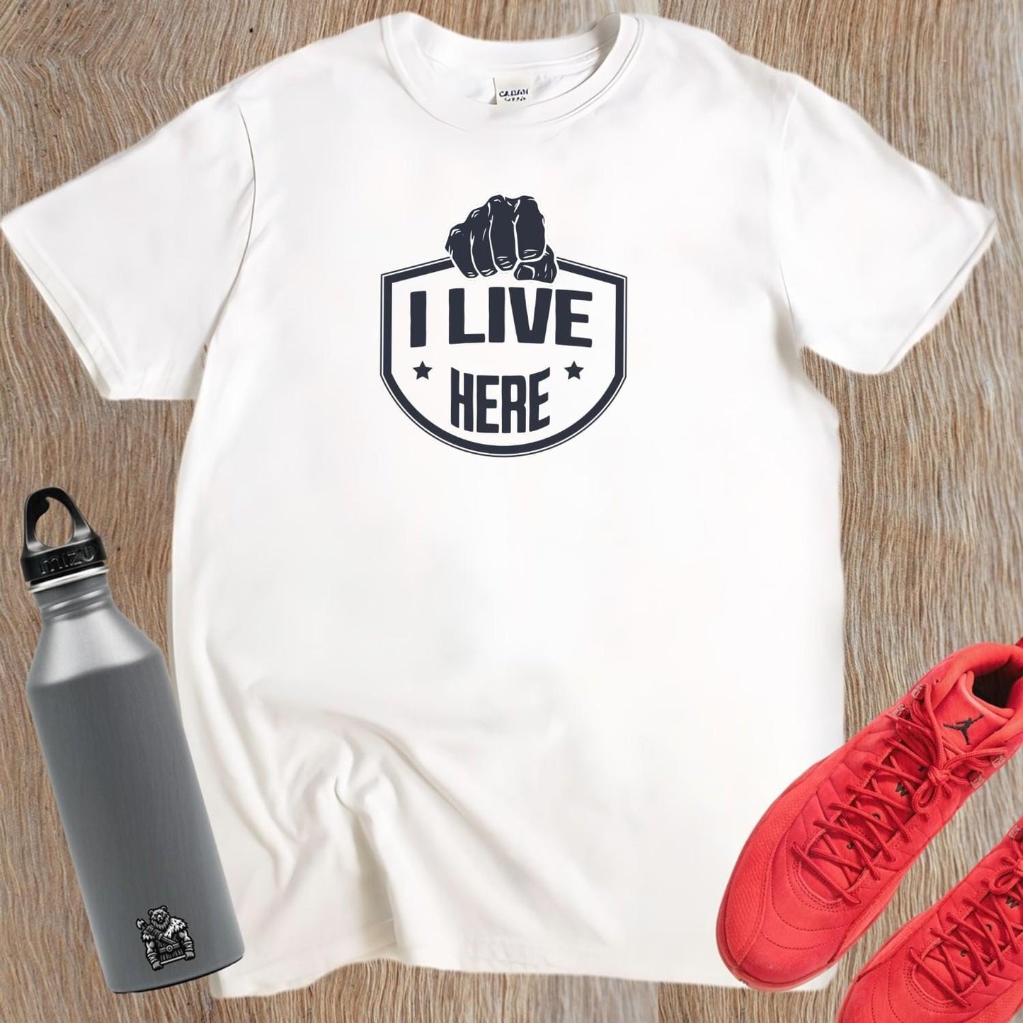 "Bold 'I Live Here' graphic tee for fitness enthusiasts, perfect for workouts and casual wear. Show your dedication to fitness!"