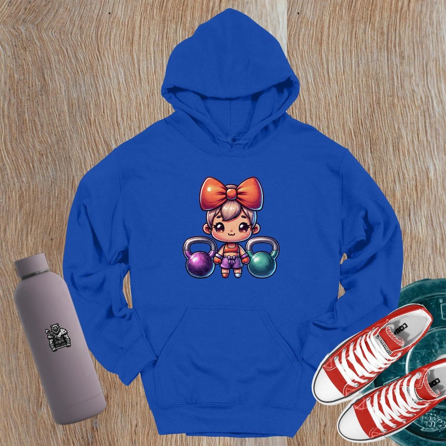 "Vibrant gym hoodie featuring a playful character lifting kettlebells, perfect blend of style and function for workouts and casual wear."