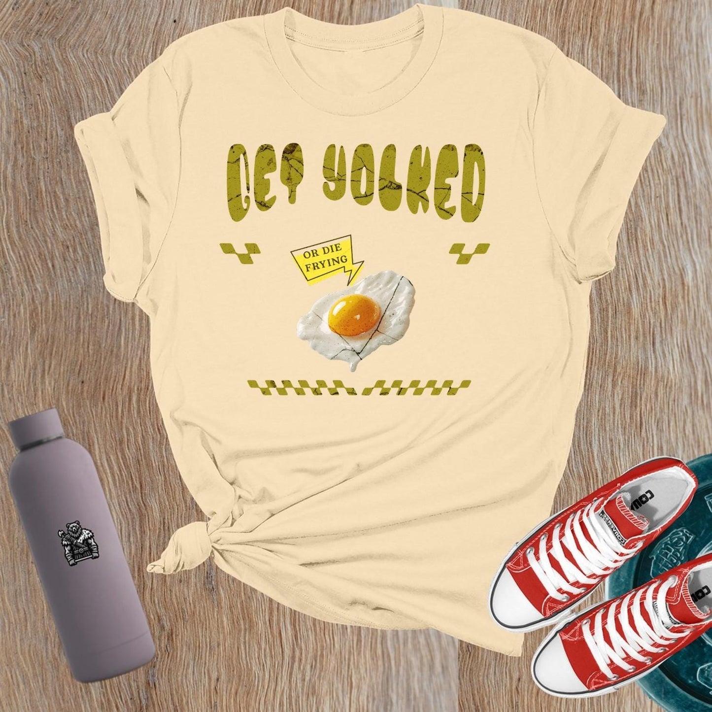 "Graphic T-shirt for women showcasing 'Get Yolked' slogan, featuring a weightlifting design, perfect for fitness enthusiasts and gym lovers."