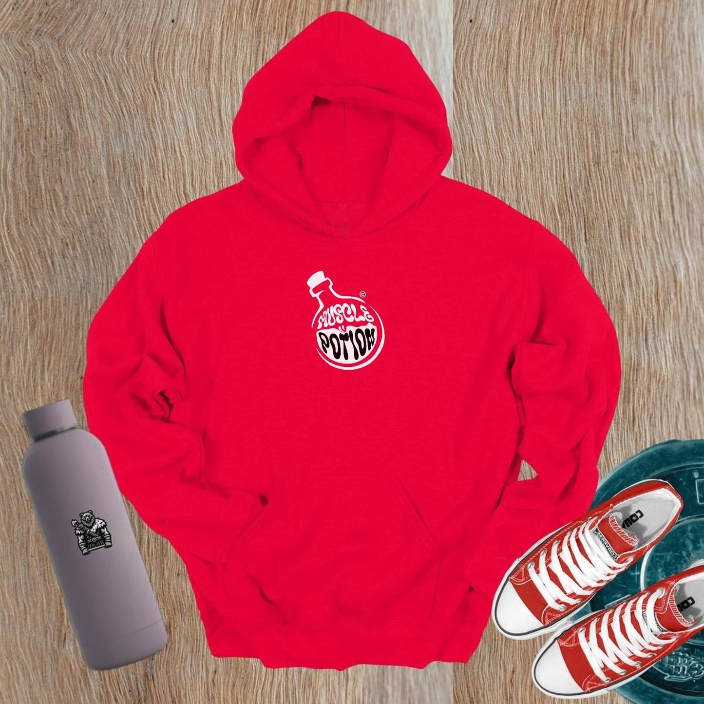 "Muscle Potion hoodie in gym setting, featuring a bold logo, perfect fit for workouts, styled with leggings for a confident look."