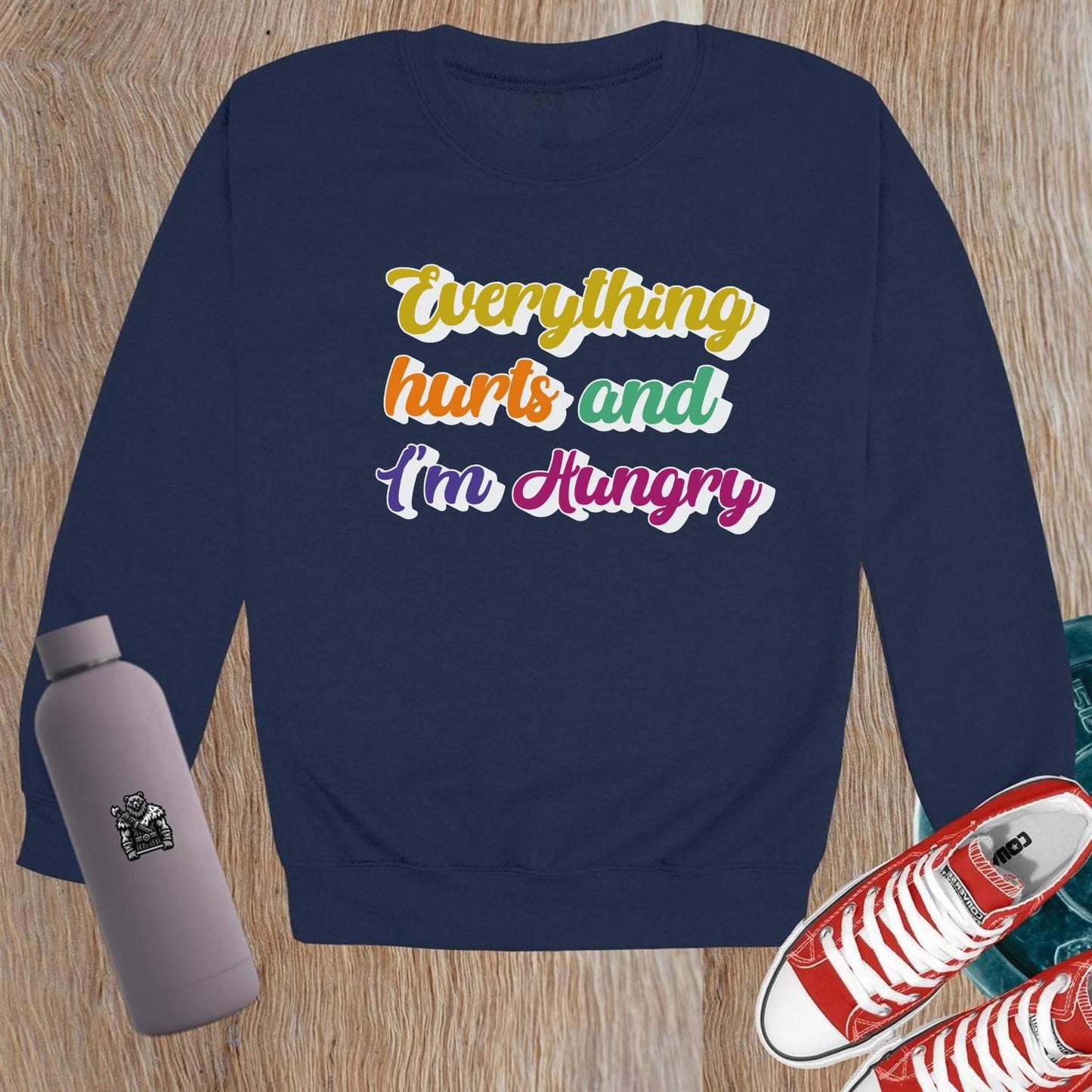 "Bold Crewneck Sweatshirt for gym-goers, featuring 'Everything hurts and I’m Hungry' in eye-catching design, perfect for workouts."