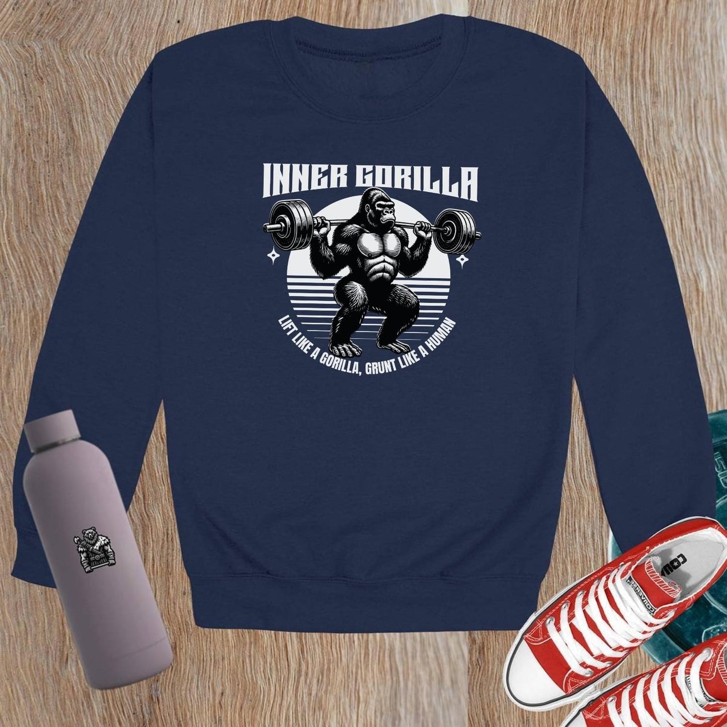 "Graphic crewneck sweatshirt featuring a powerful gorilla lifting weights with the motivational slogan 'Lift Like a Gorilla, Grunt Like a Human.' Ideal for fitness enthusiasts, this stylish gym apparel combines comfort and inspiration for workouts or casual wear."
