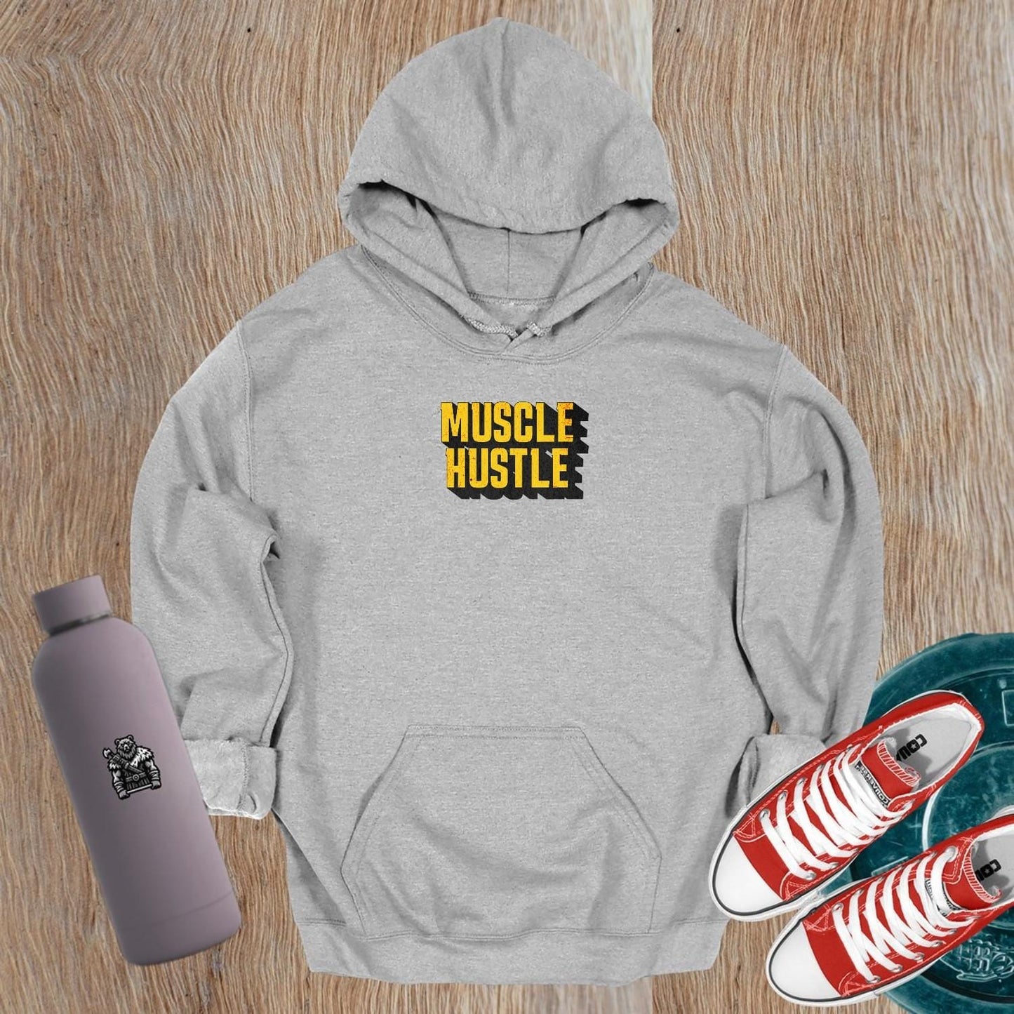Alt text: "Muscle Hustle hoodie featuring a bold graphic design that symbolizes strength and determination, perfect for fitness enthusiasts."