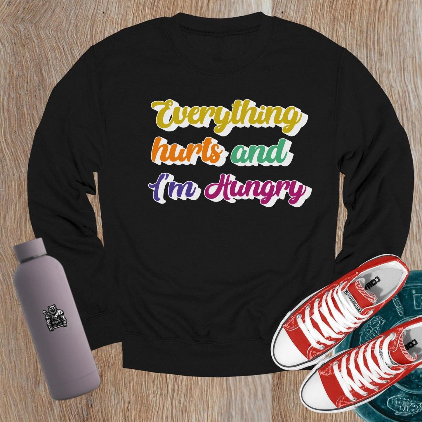 "Bold Crewneck Sweatshirt for gym-goers, featuring 'Everything hurts and I’m Hungry' in eye-catching design, perfect for workouts."