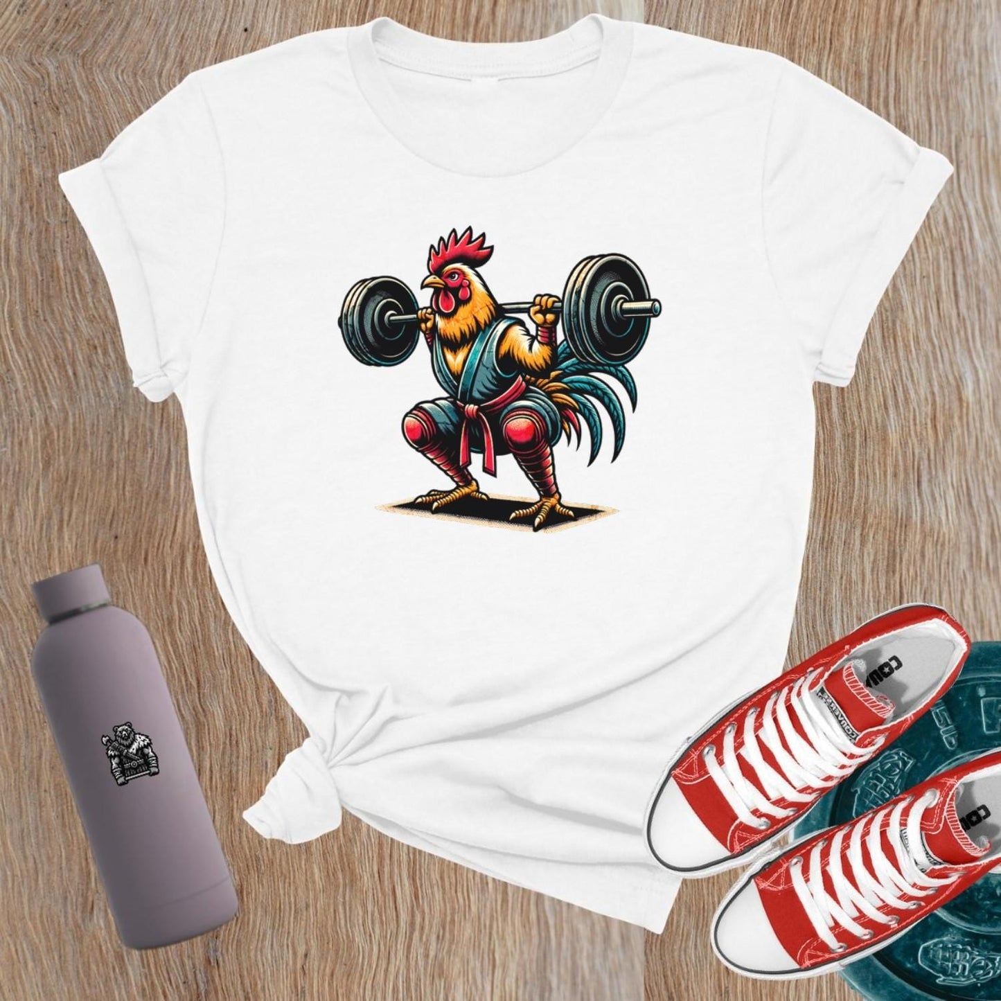 Bold gym T-shirt featuring a fiercely squatting rooster, symbolizing empowerment and determination for women who lift weights.