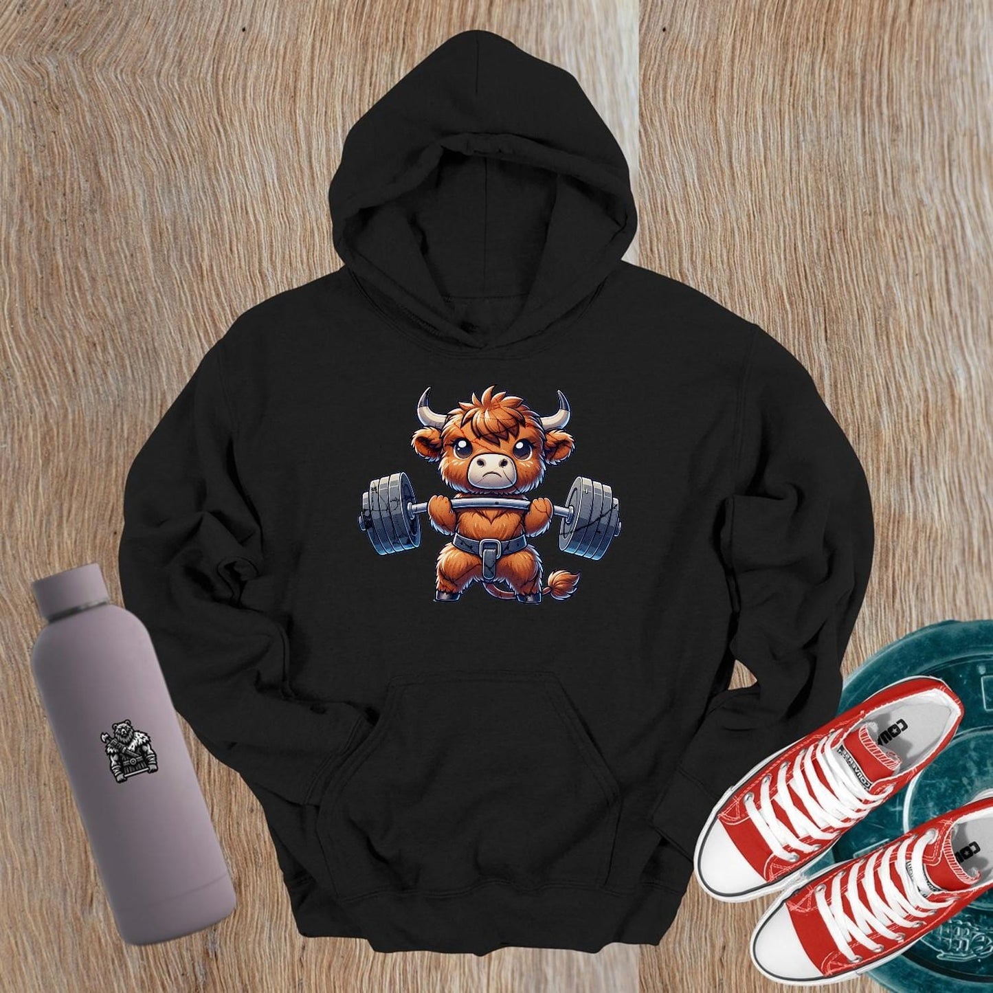 "Cartoon bull lifting weights on a stylish gym hoodie, embodying strength and motivation for gym enthusiasts and fitness lovers."