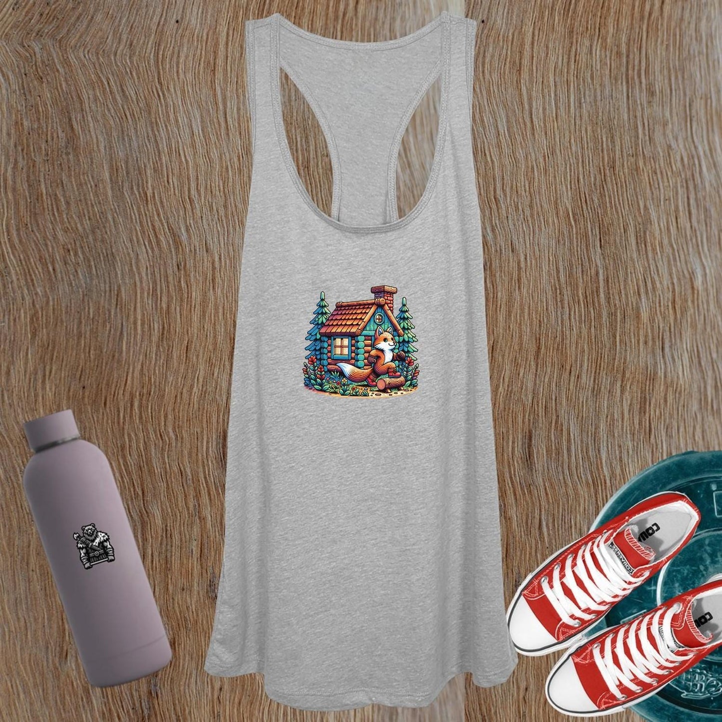 Whimsical women's tank top featuring a charming fox by a cozy cabin, perfect for gym workouts or casual outings; stylish and comfortable.