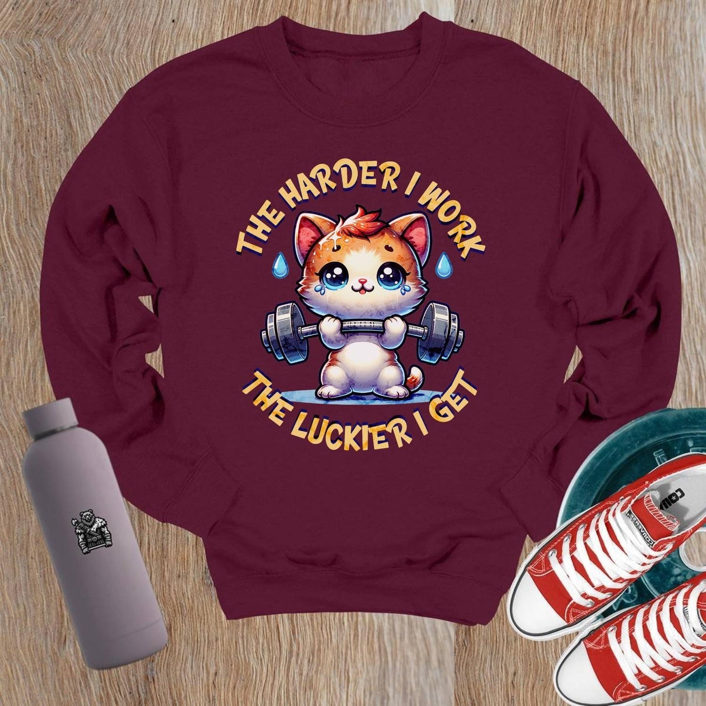 "Adorable crewneck sweatshirt featuring a cartoon kitty lifting weights, motivational design, perfect for gym workouts and lounging."
