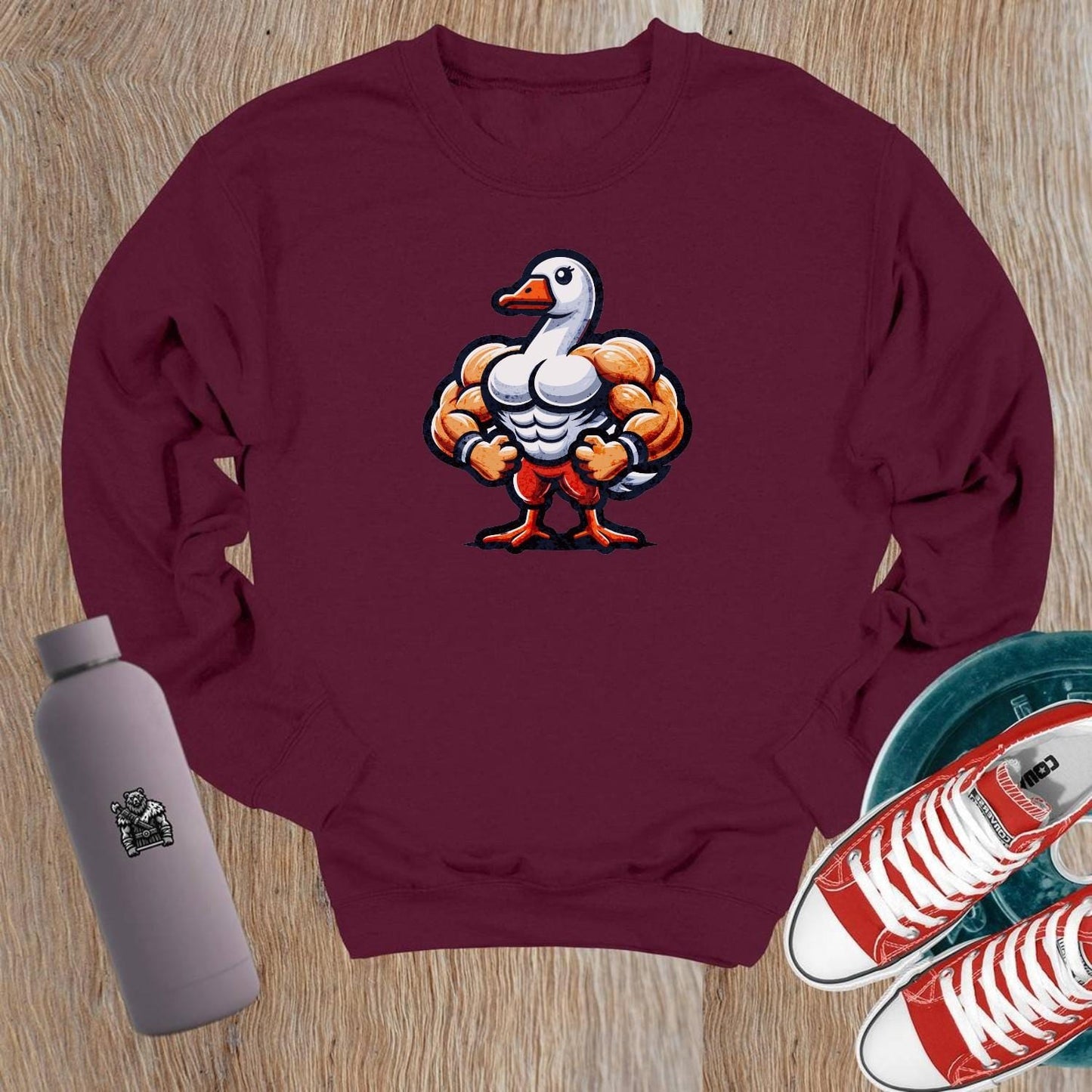 "Graphic crewneck sweatshirt featuring a playful muscular duck design, perfect for gym workouts or casual wear. Bold and unique!"