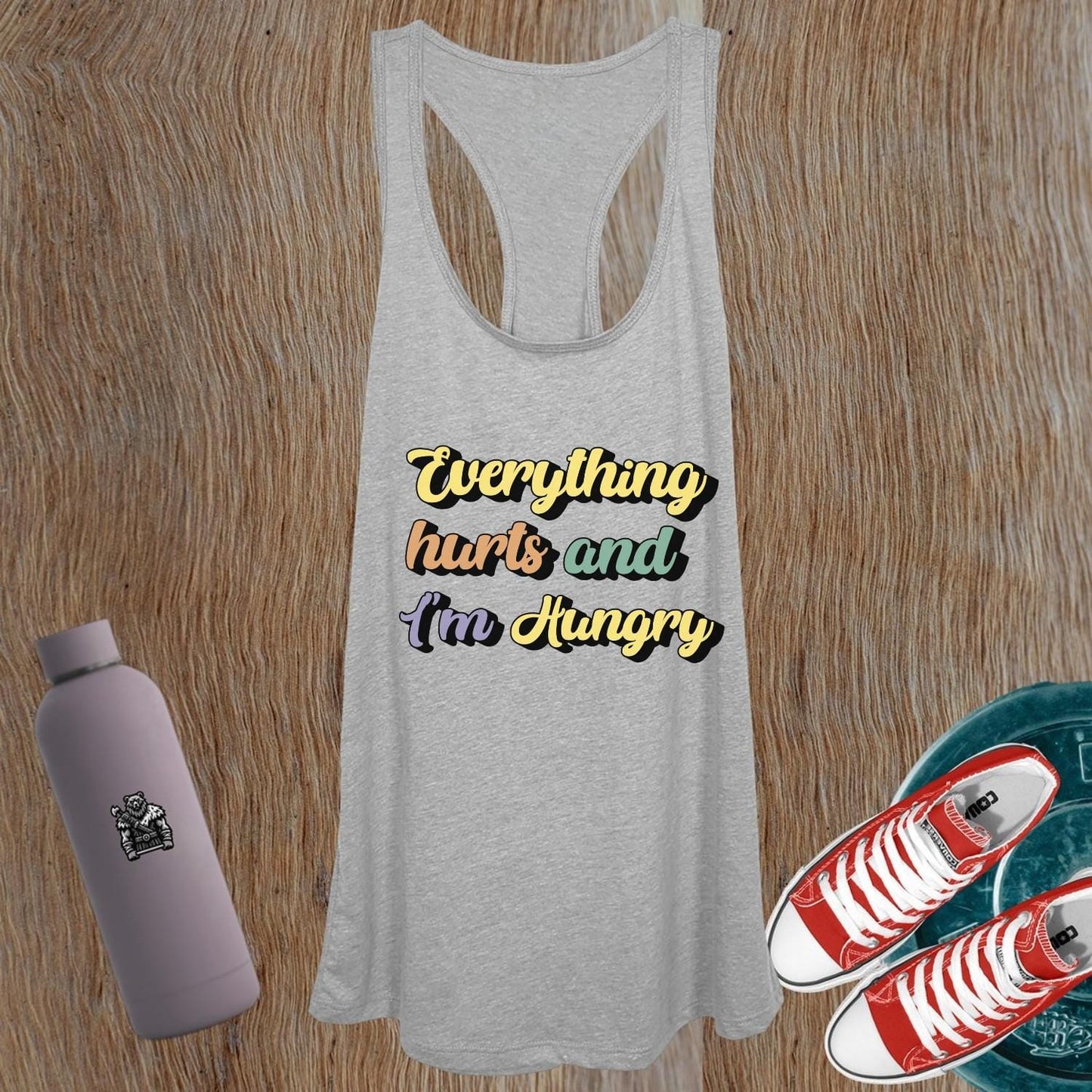 "Women's gym tank top featuring playful phrase 'Everything hurts and I’m Hungry', perfect for fitness enthusiasts and workouts."