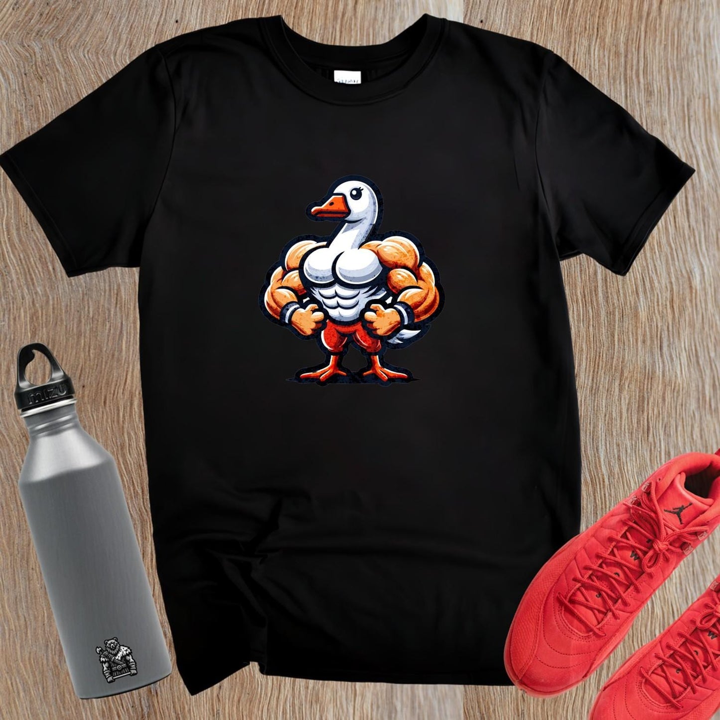 "Bold gym T-shirt featuring a muscle-bound goose design, perfect for workouts, fitness enthusiasts, and making a fun statement."