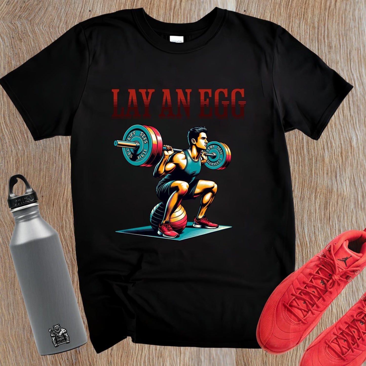 "Graphic gym T-shirt featuring 'Lay An Egg' design, showcasing humor in fitness. Ideal for workouts, casual outings, and style."