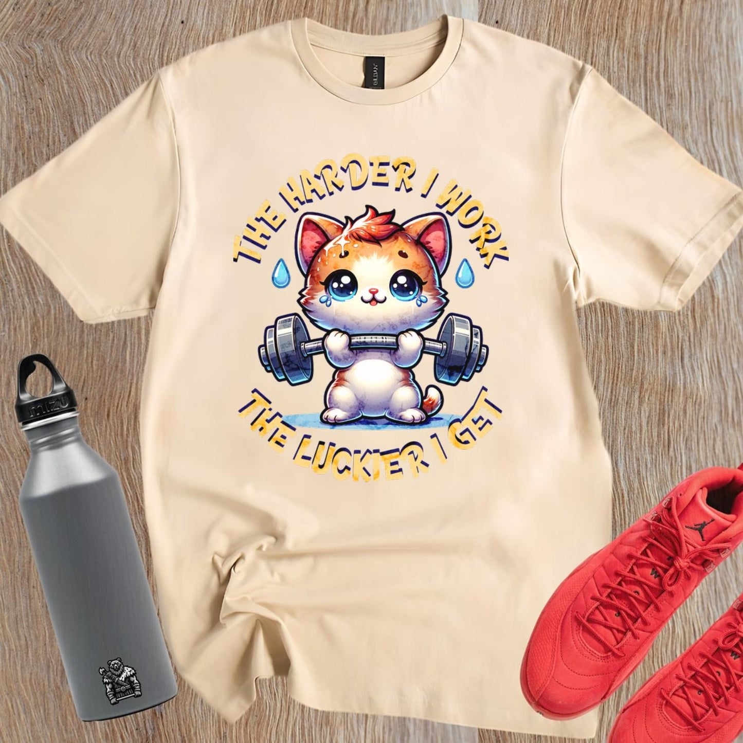 "Vibrant gym T-shirt featuring a determined kitty lifting weights, inspiring fitness enthusiasts with playful motivation for workouts."