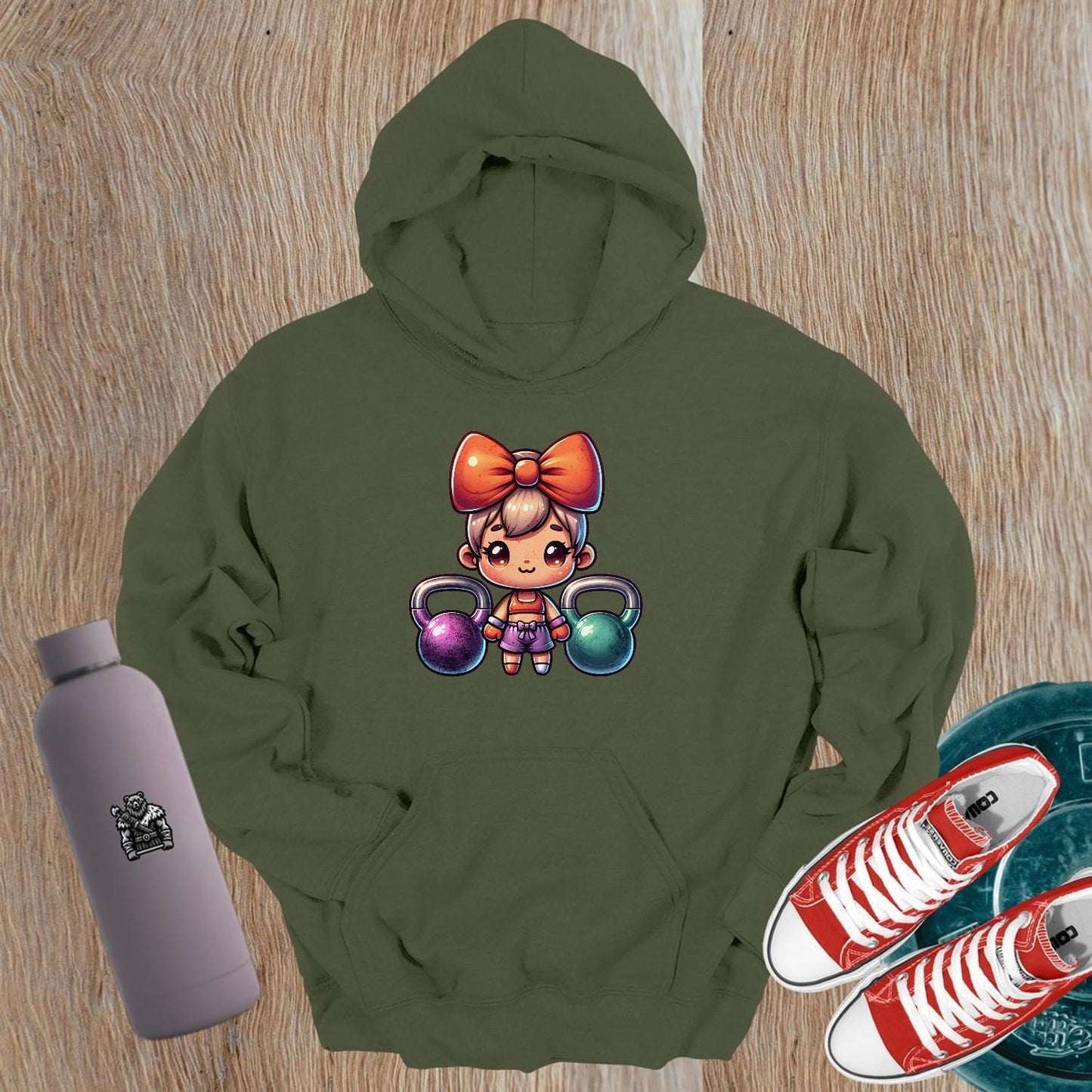 "Vibrant gym hoodie featuring a playful character lifting kettlebells, perfect blend of style and function for workouts and casual wear."