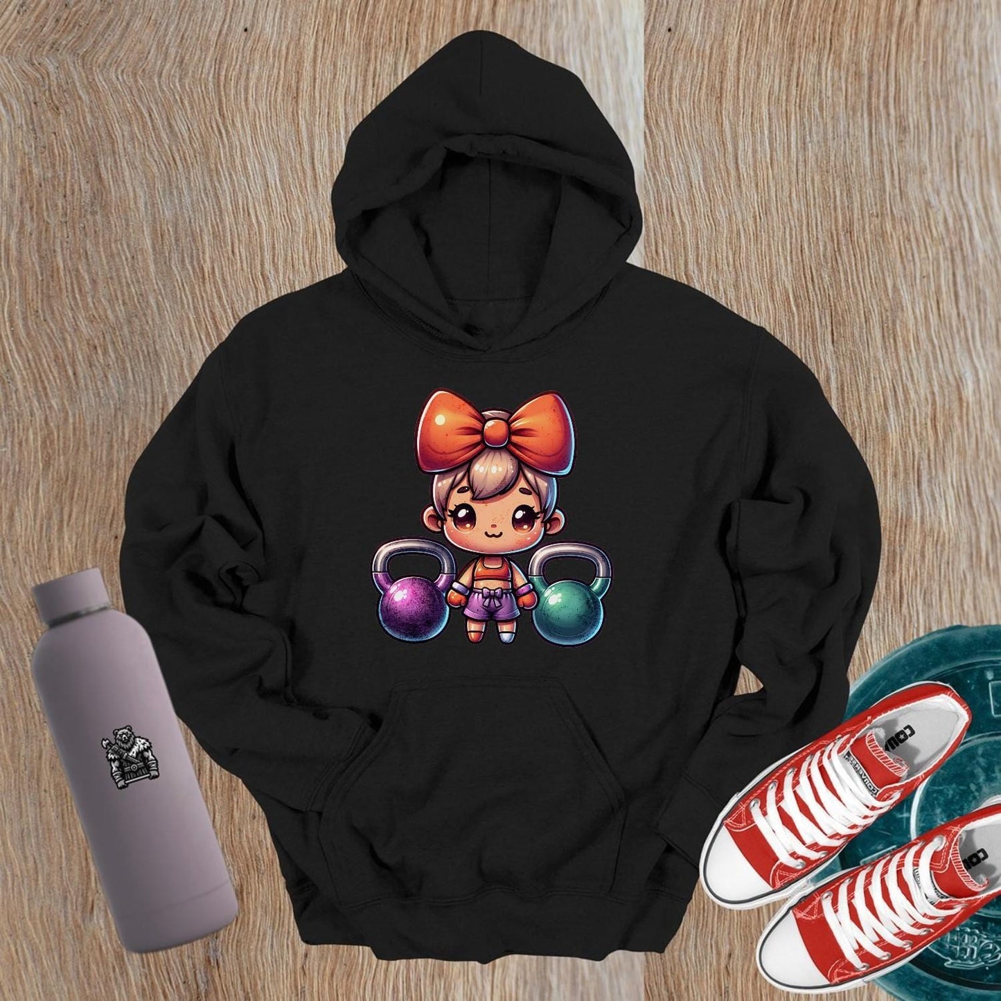 "Vibrant gym hoodie featuring a playful character lifting kettlebells, perfect blend of style and function for workouts and casual wear."