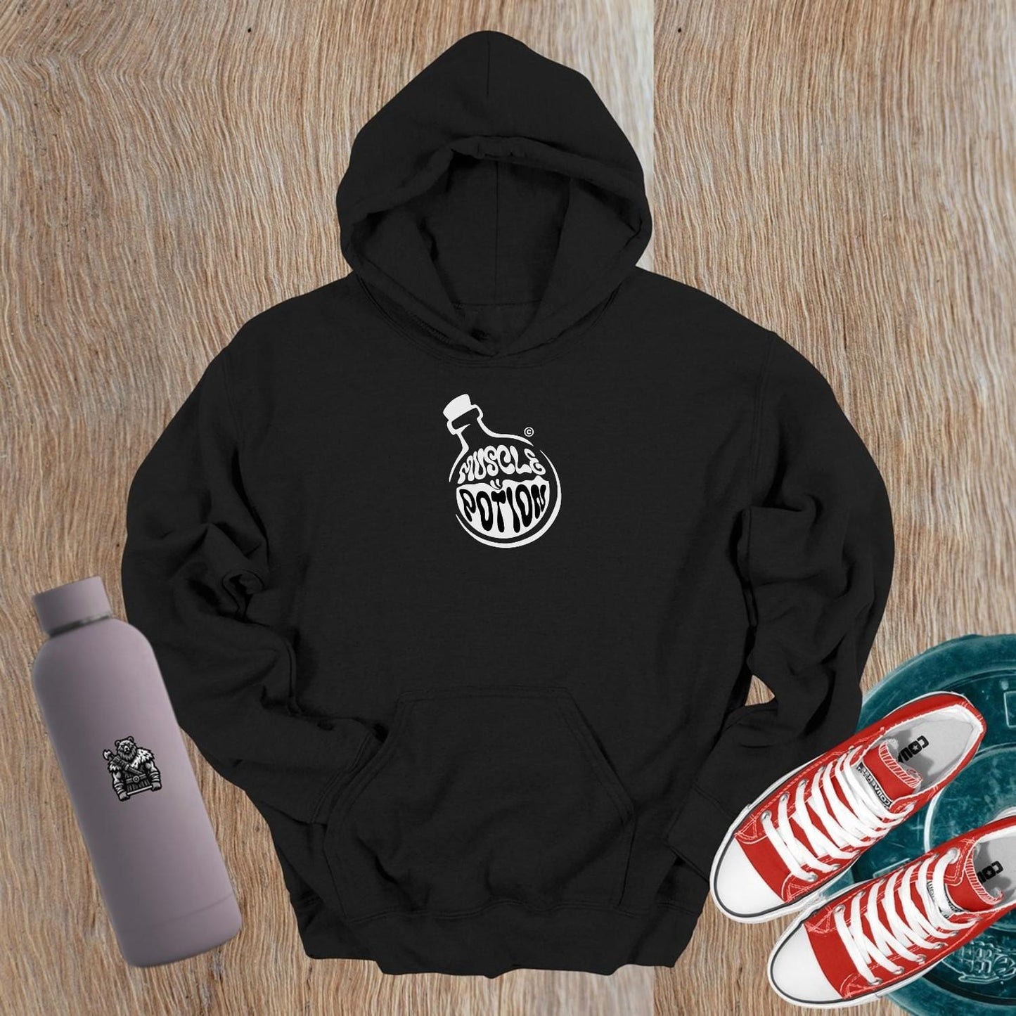 "Muscle Potion hoodie in gym setting, featuring a bold logo, perfect fit for workouts, styled with leggings for a confident look."