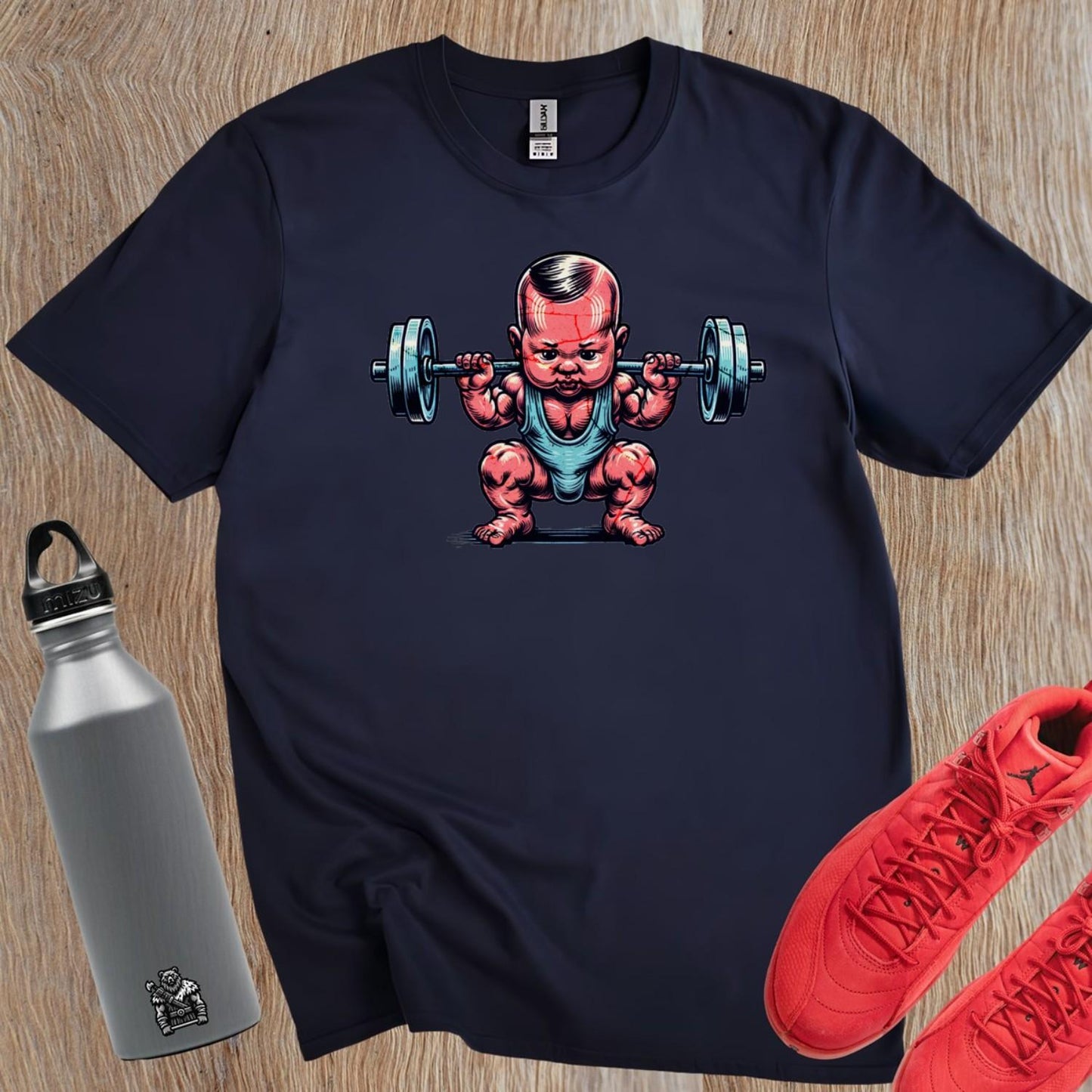 "Fun gym T-shirt featuring a charming baby lifting weights, combining humor and strength for fitness enthusiasts. Perfect for workouts!"