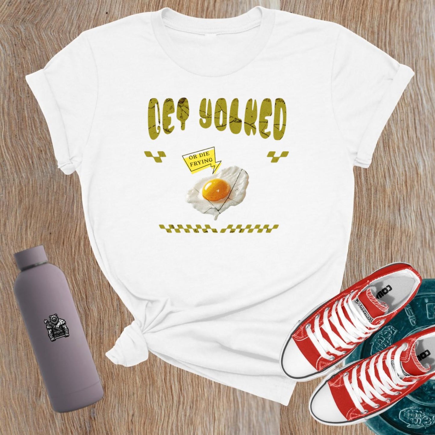 "Graphic T-shirt for women showcasing 'Get Yolked' slogan, featuring a weightlifting design, perfect for fitness enthusiasts and gym lovers."