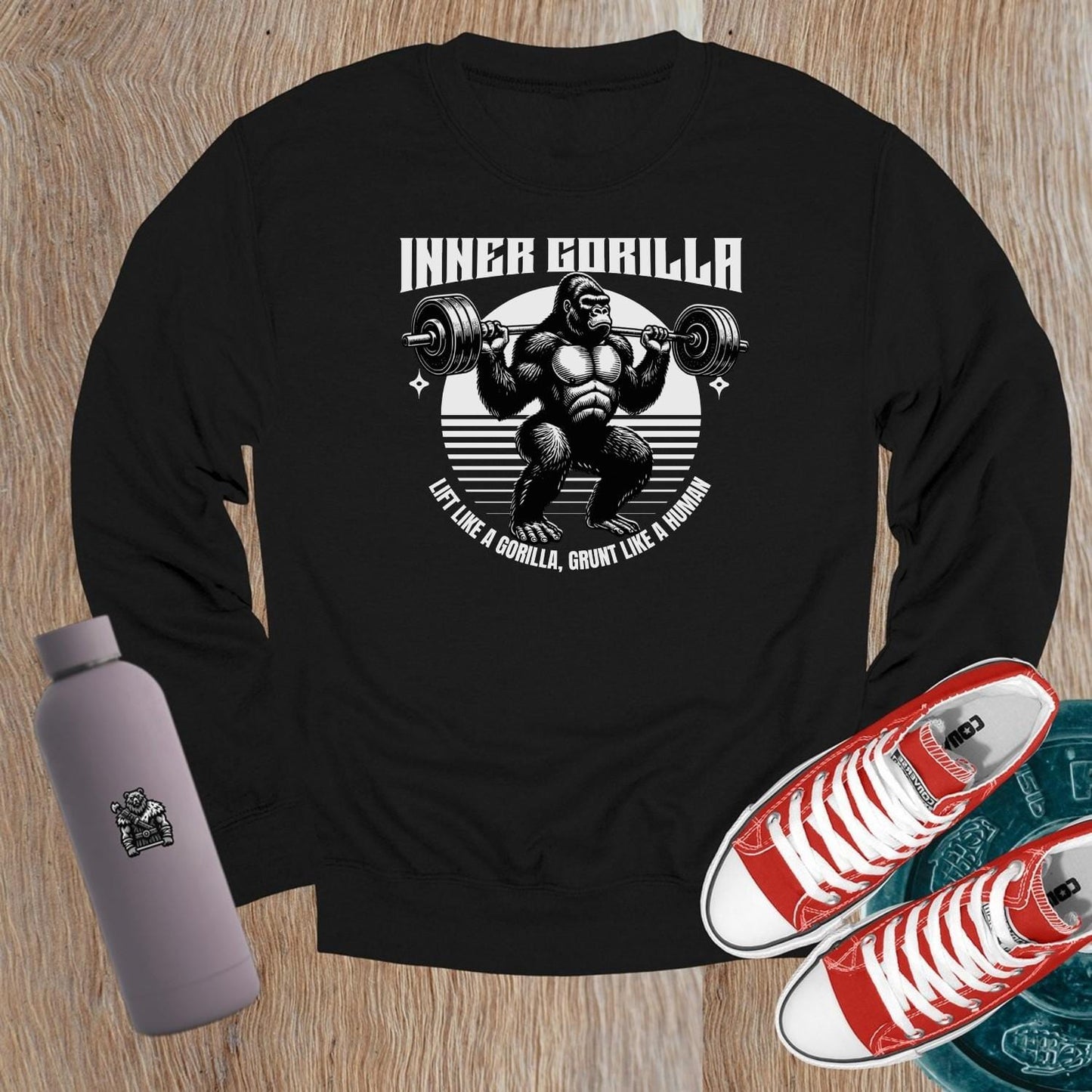 "Graphic crewneck sweatshirt featuring a powerful gorilla lifting weights with the motivational slogan 'Lift Like a Gorilla, Grunt Like a Human.' Ideal for fitness enthusiasts, this stylish gym apparel combines comfort and inspiration for workouts or casual wear."