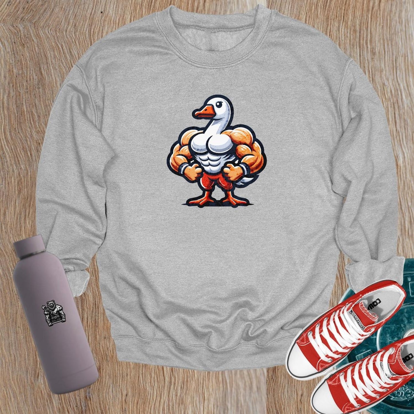 Alt text: "Bold graphic sweatshirt featuring a muscular goose, combining humor and motivation for fitness. Perfect for gym or casual wear."