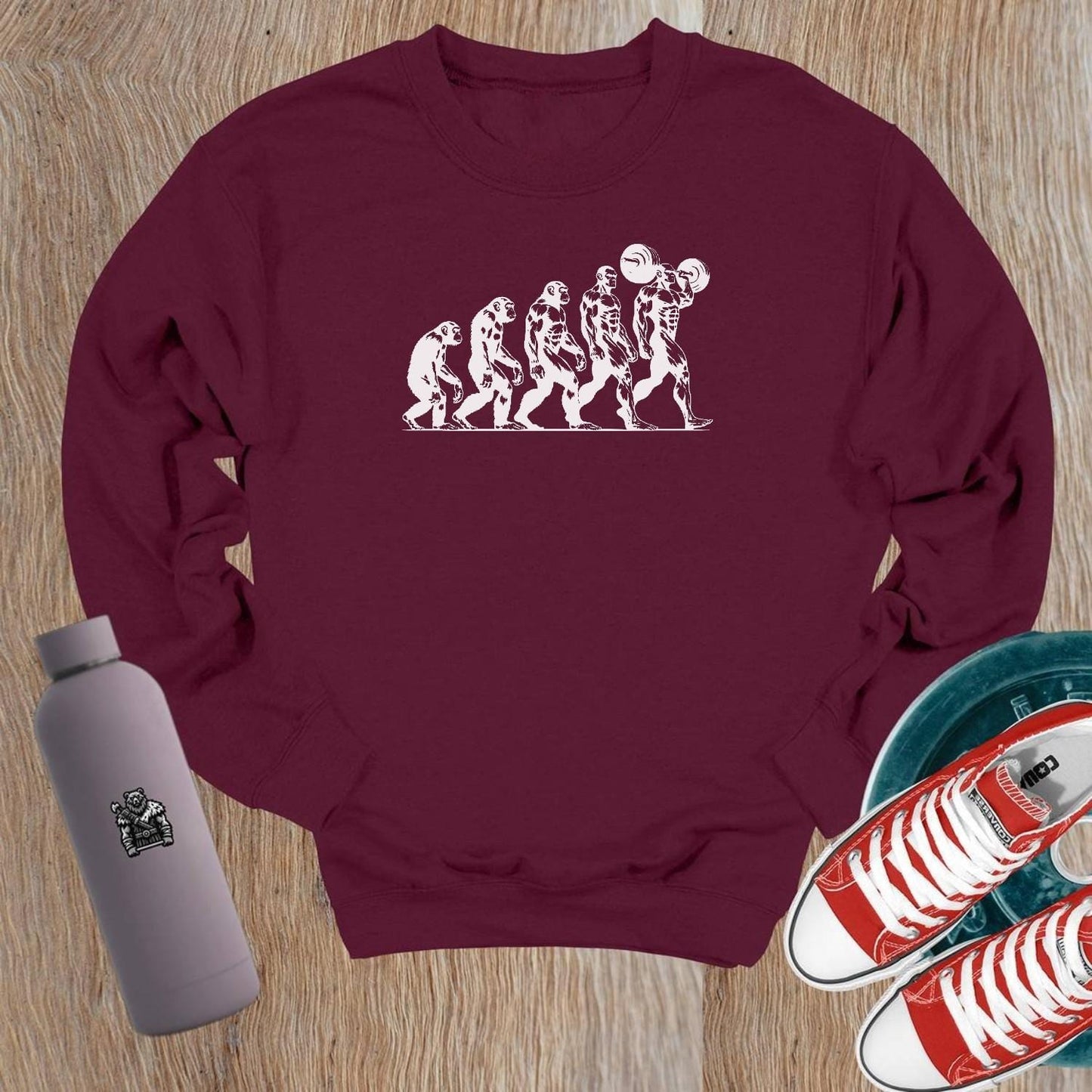 "Graphic gym crewneck sweatshirt featuring bold 'Evolution' design, perfect for fitness enthusiasts to showcase strength and transformation."