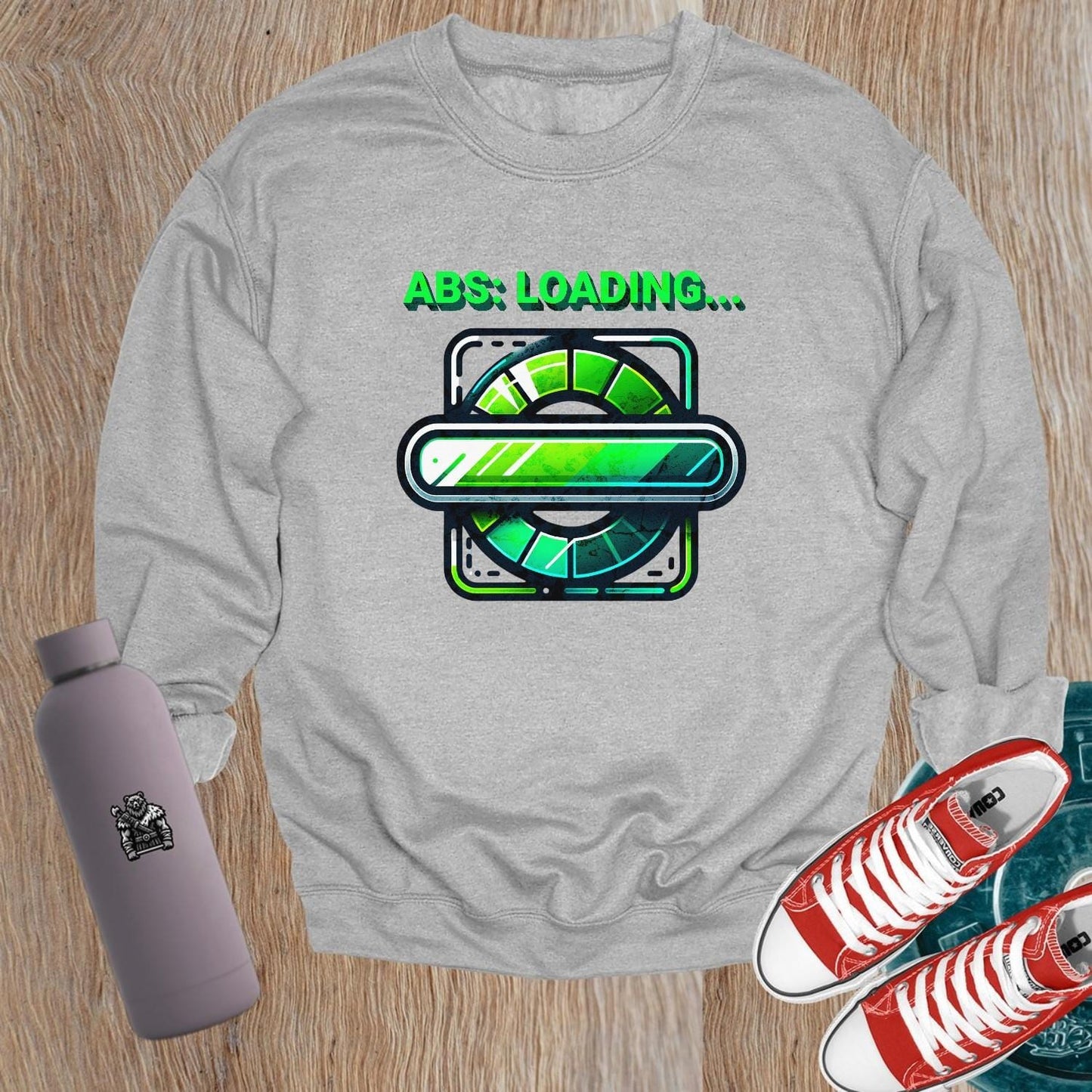 "Lightweight gray crewneck sweatshirt featuring 'ABS: LOADING...' graphic. Perfect for gym workouts and casual wear, showcasing fitness focus."