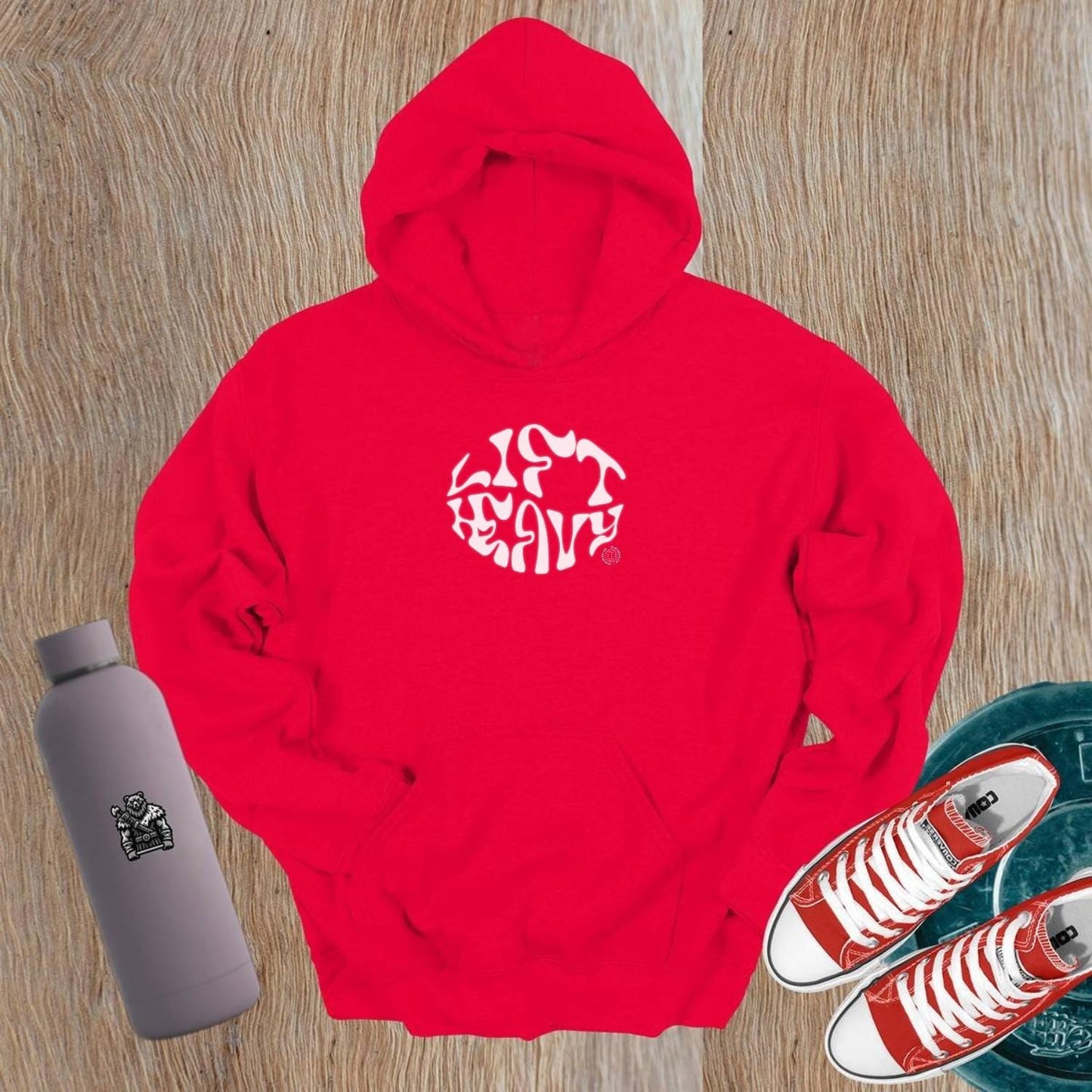 "Bold 'Lift Heavy' hoodie for gym enthusiasts featuring an inspiring graphic, perfect for workouts and everyday wear, combining comfort and style."