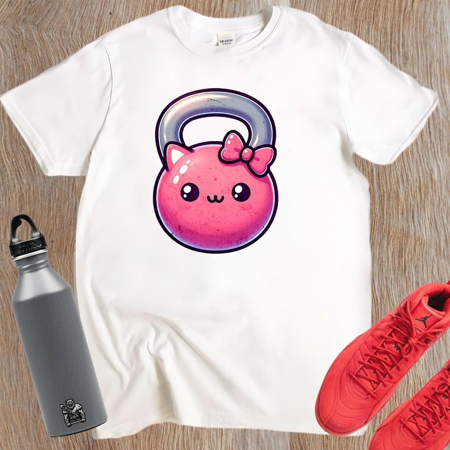 Alt text: "Kawaii Kettlebell T-shirt featuring a cute pink kettlebell with a bow, perfect for gym workouts and stylish casual wear."